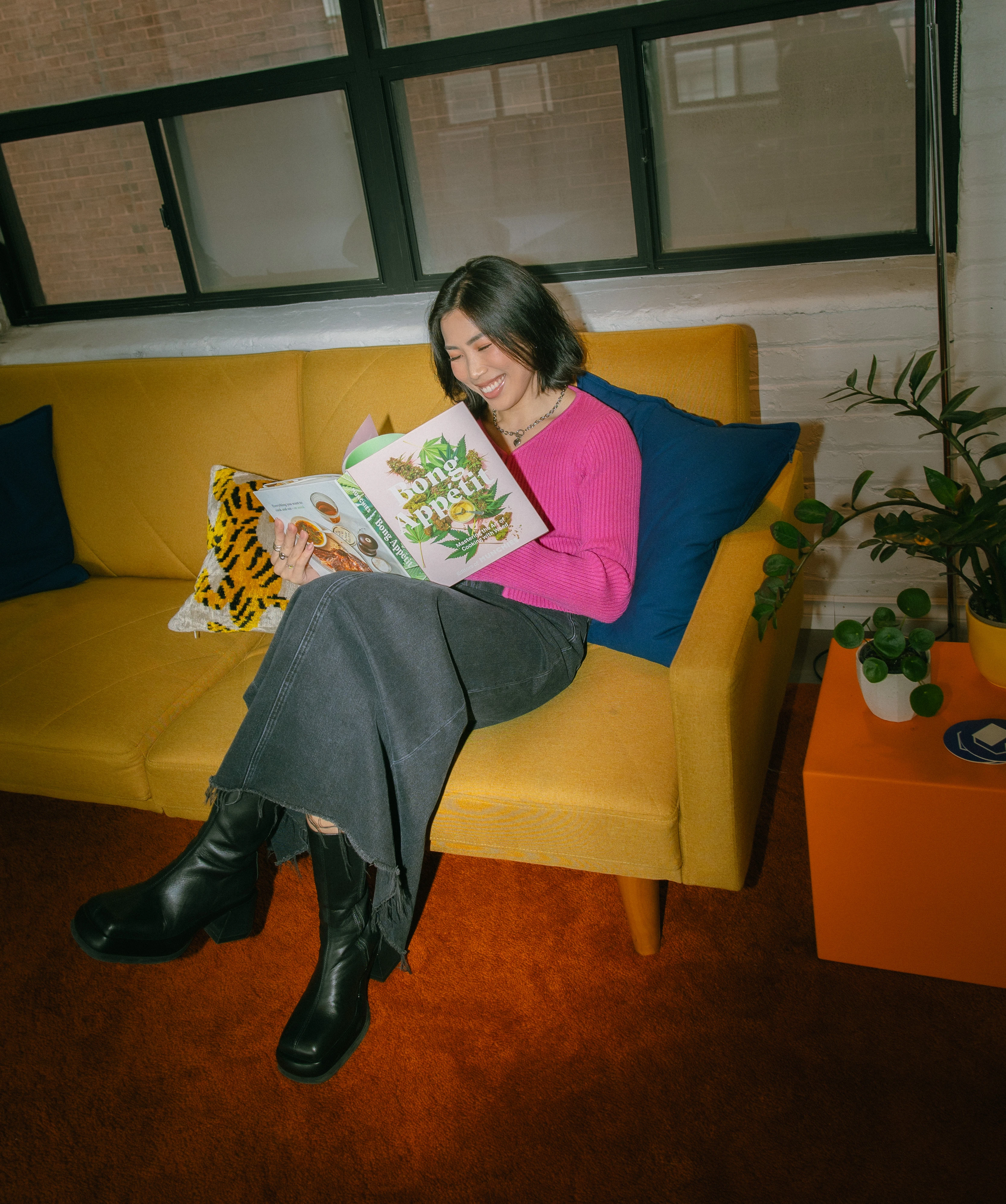 A thumbnail photo of Anna The Cannabinista with her hand in a fist resting on the side of her chin, looking directly at the camera. Around her body is text that reads "mental health", "munchies", "mindful consumption", "physical health" and more.