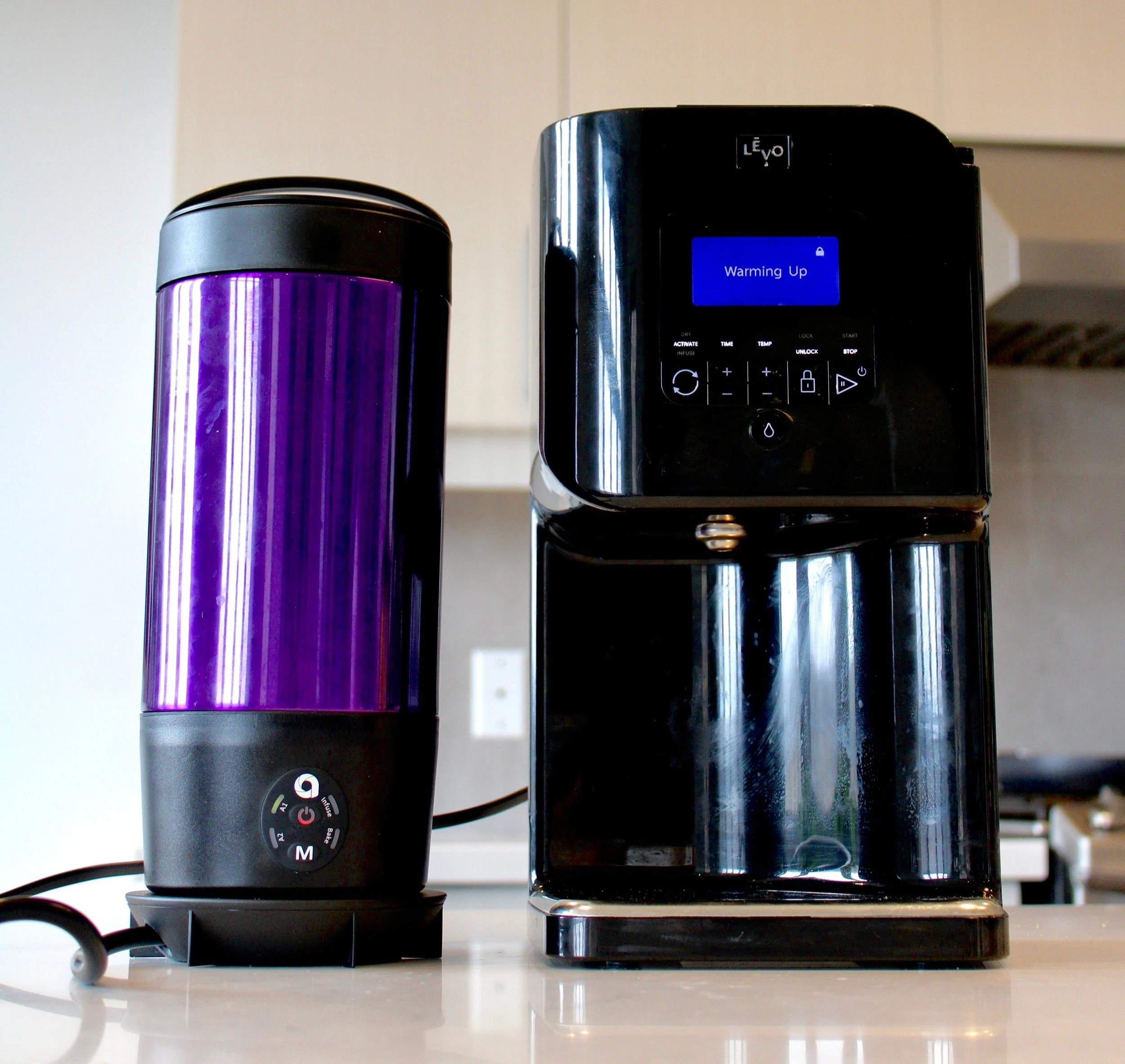 An ardent and Levo cannabis infusion device standing side by side.