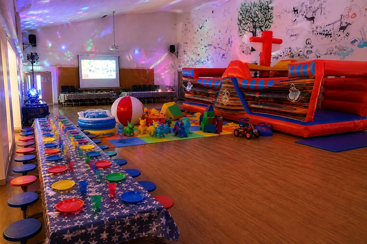 Play-ready party hall in London with soft play, inflatable activity zone and children’s table setup | Partyfer