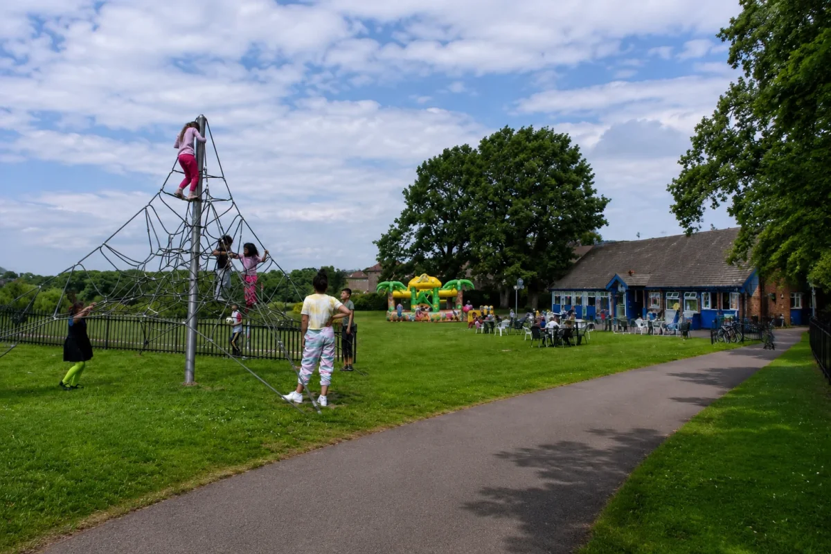Outdoor café and park-style birthday near Woodside Park with climbing play, open lawn and a clear park pathway | Partyfer