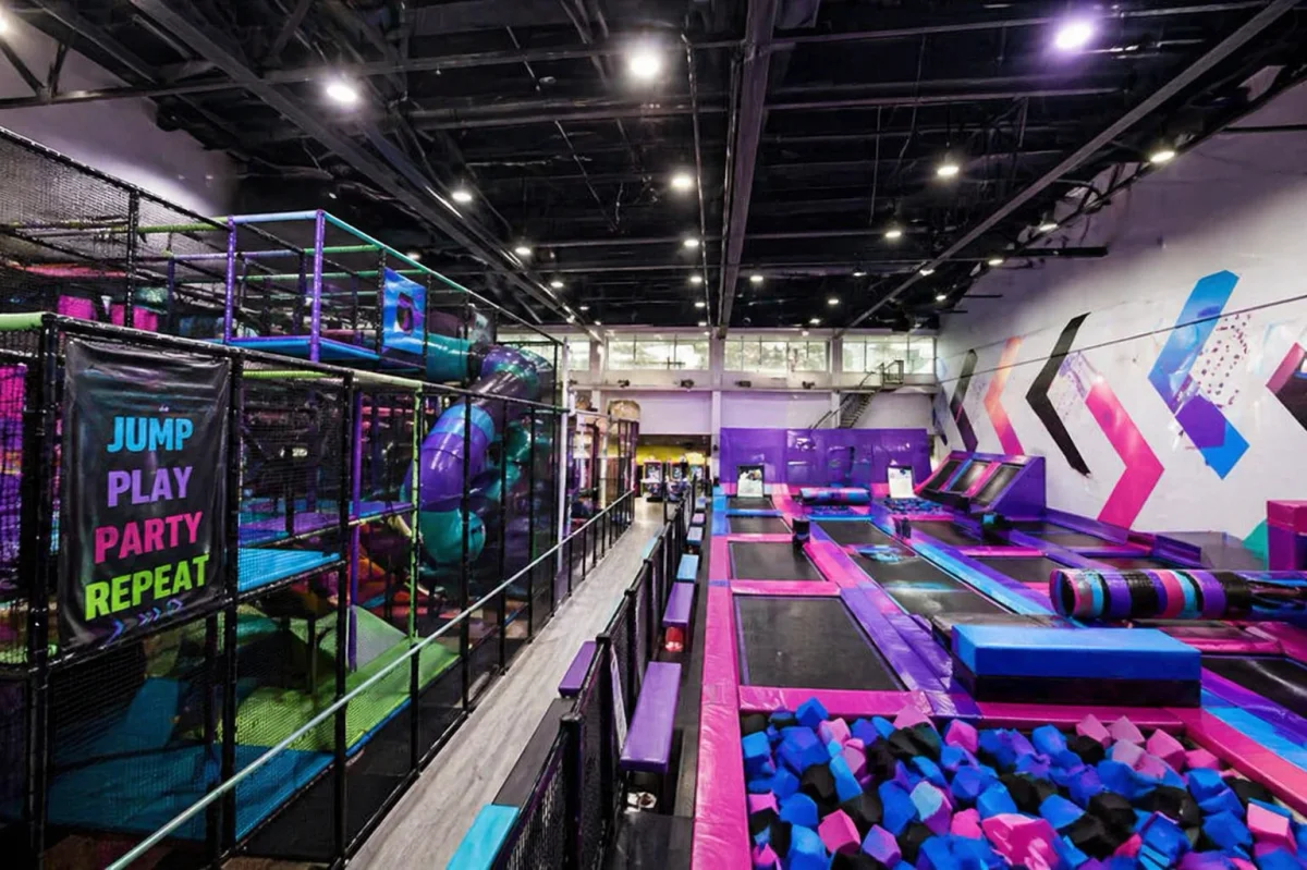 Large indoor trampoline and activity arena with a multi-zone play layout | Partyfer