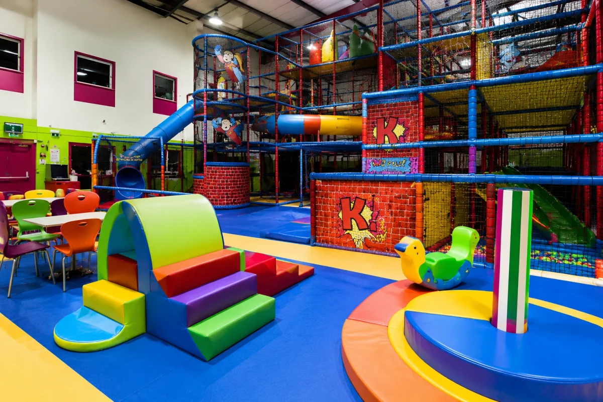 Soft play venue for younger children with climbing frames, slides and family-friendly seating | Partyfer