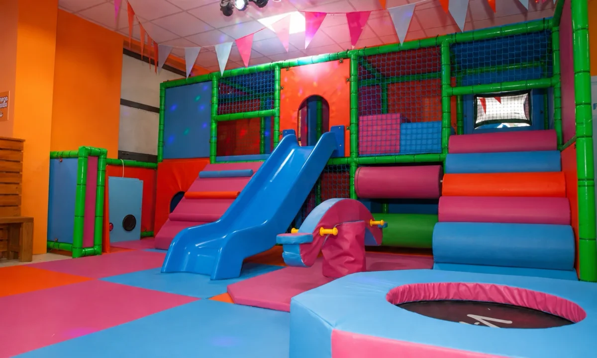 Younger-child soft playroom with padded slides, climbing panels and colourful play zones | Partyfer