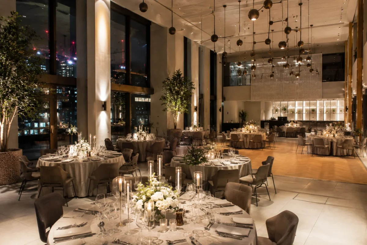 Modern statement engagement party venue with city views, candlelit tables and a contemporary event-space setup | Partyfer