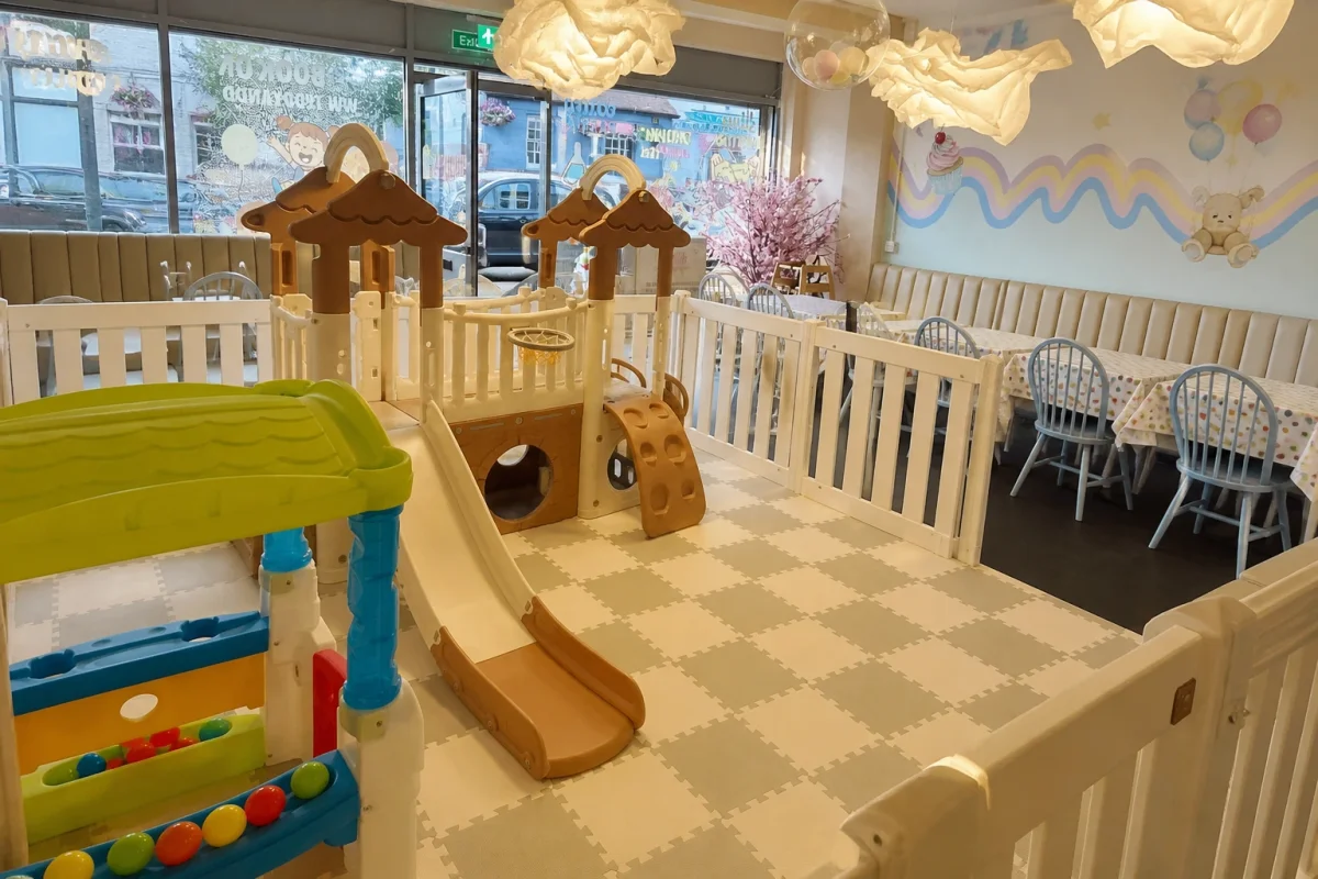 Toddler play café with a fenced soft play zone and family seating area | Partyfer