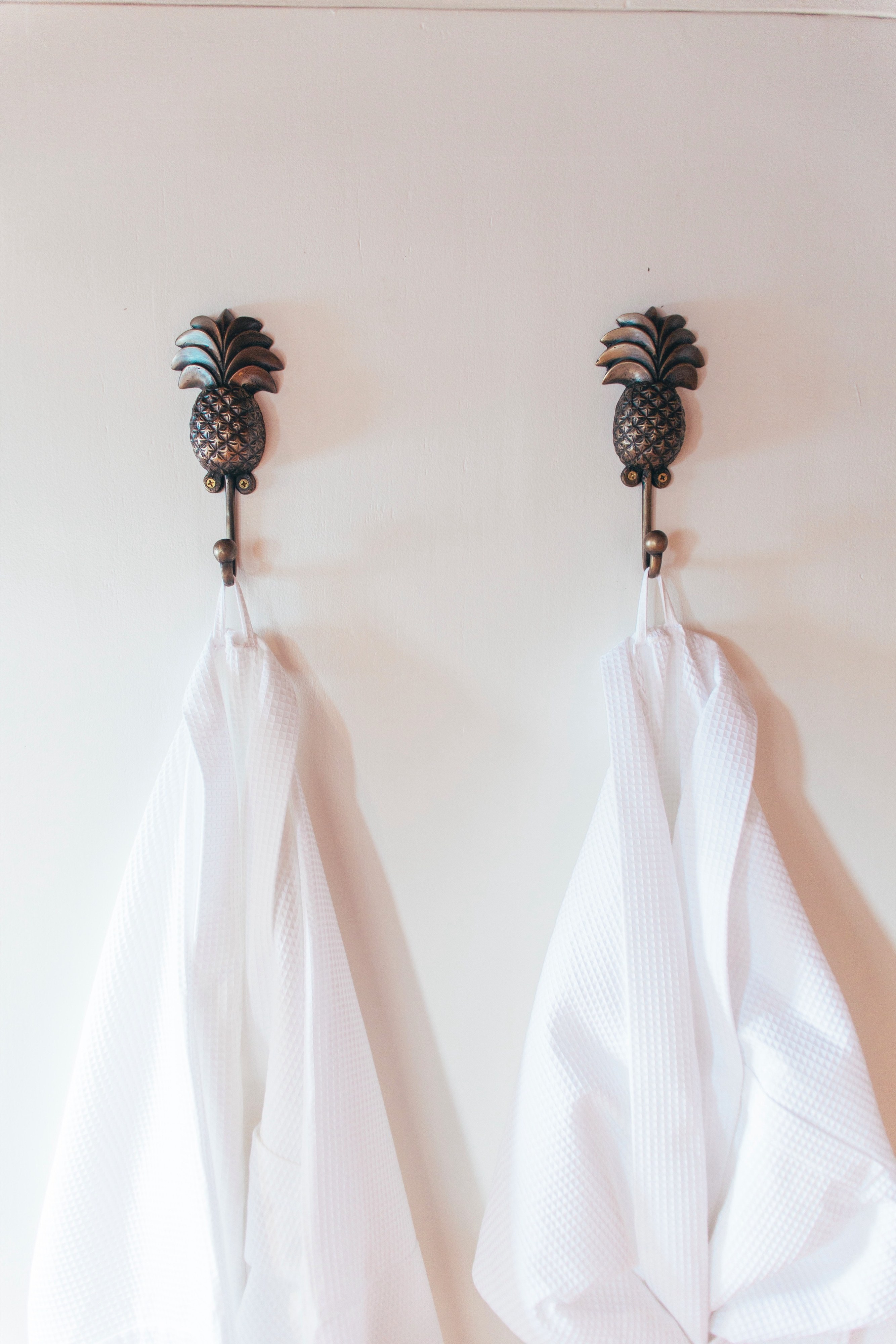 White robes on pineapple hooks in the cabin