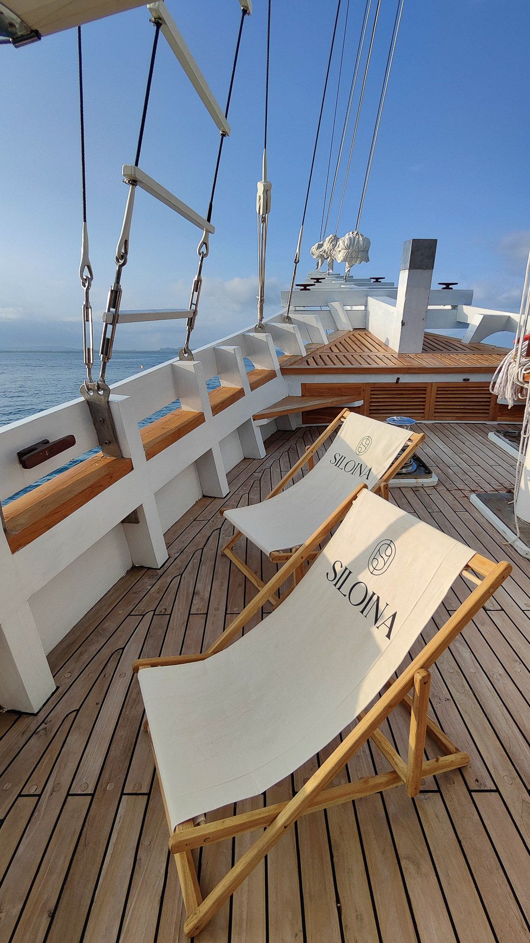 Canvas deck chairs on the teak deck of Siloina.