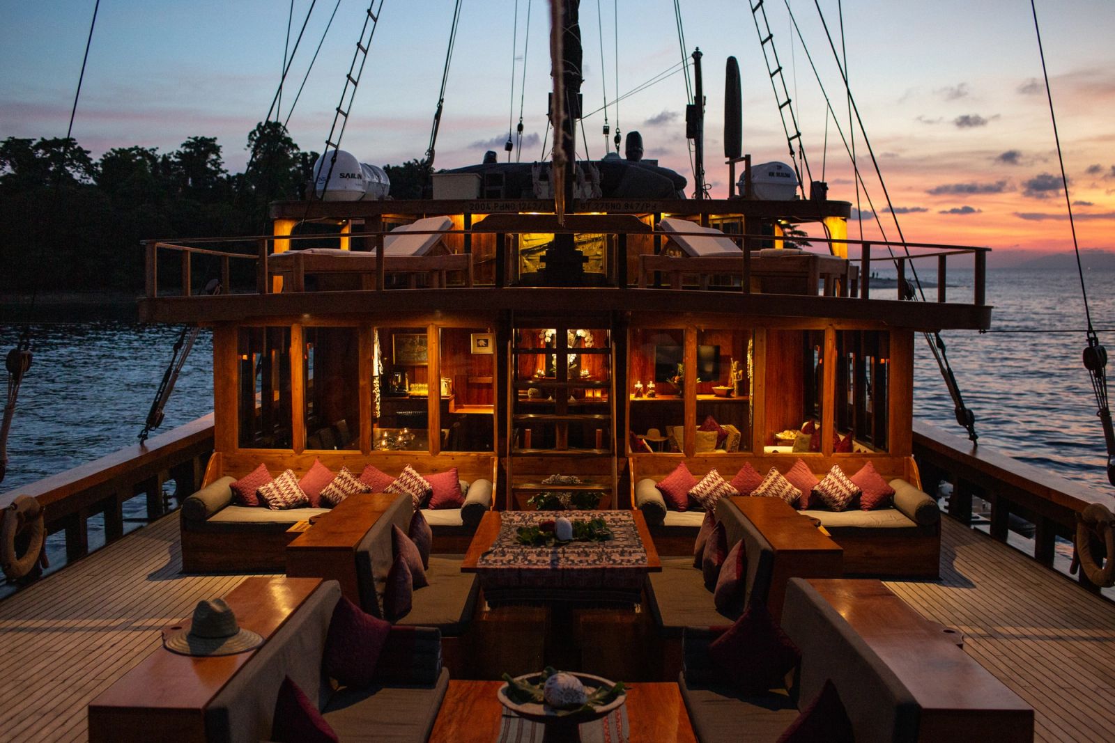 Silolona's main deck saloon lit at sunset