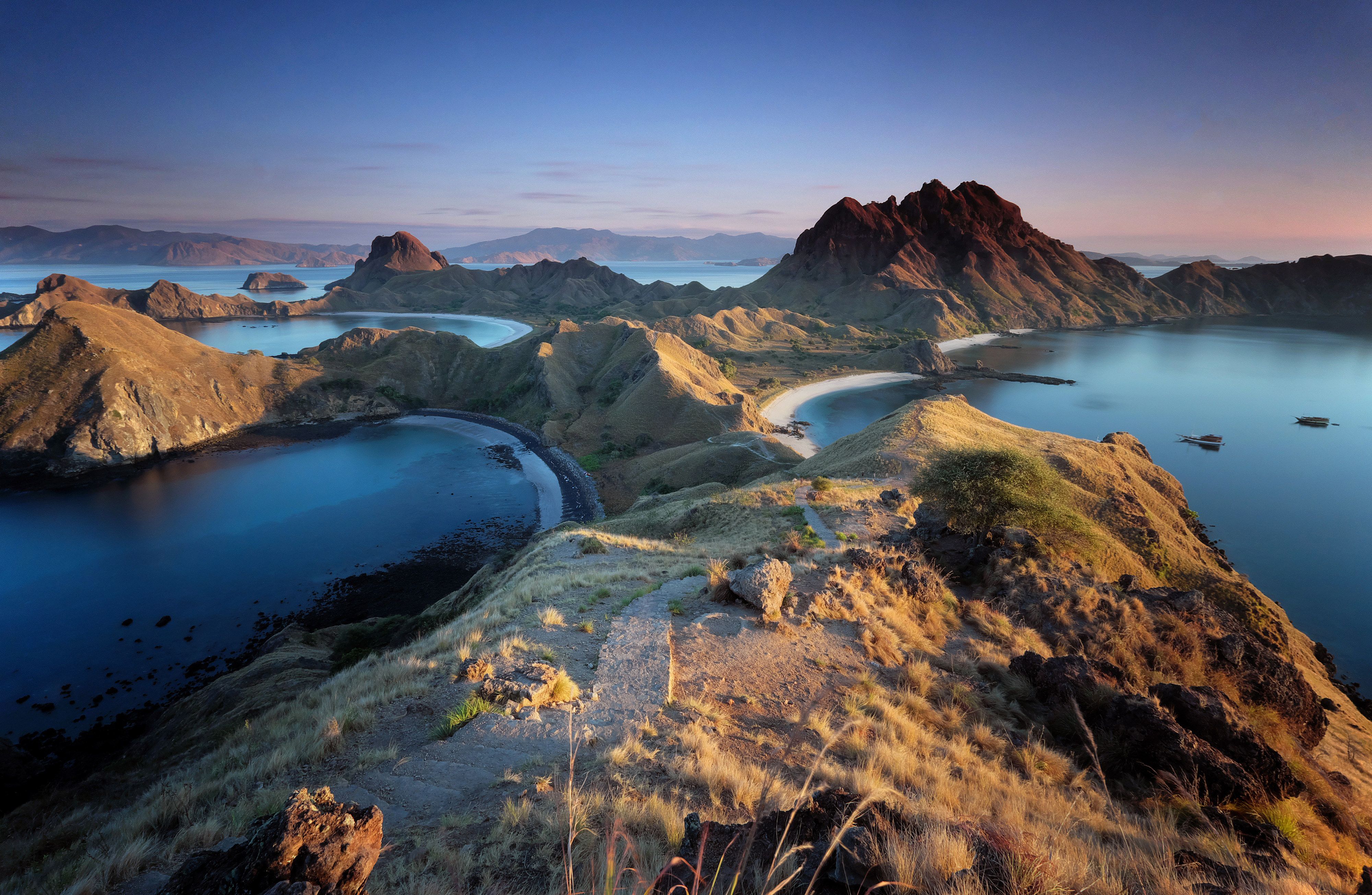The dry ridgelines and twin bays of Padar at dusk in Komodo National Park