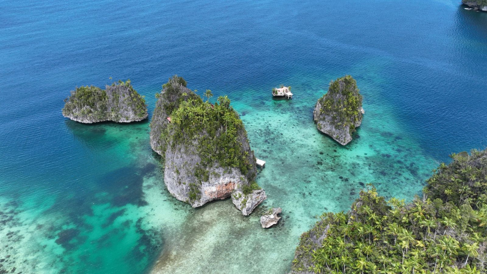 Limestone islets rise from turquoise shallows in Triton Bay, near Kaimana.