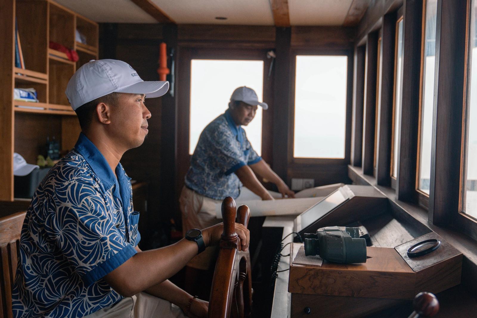 The captain at the helm, with the crew close at hand.