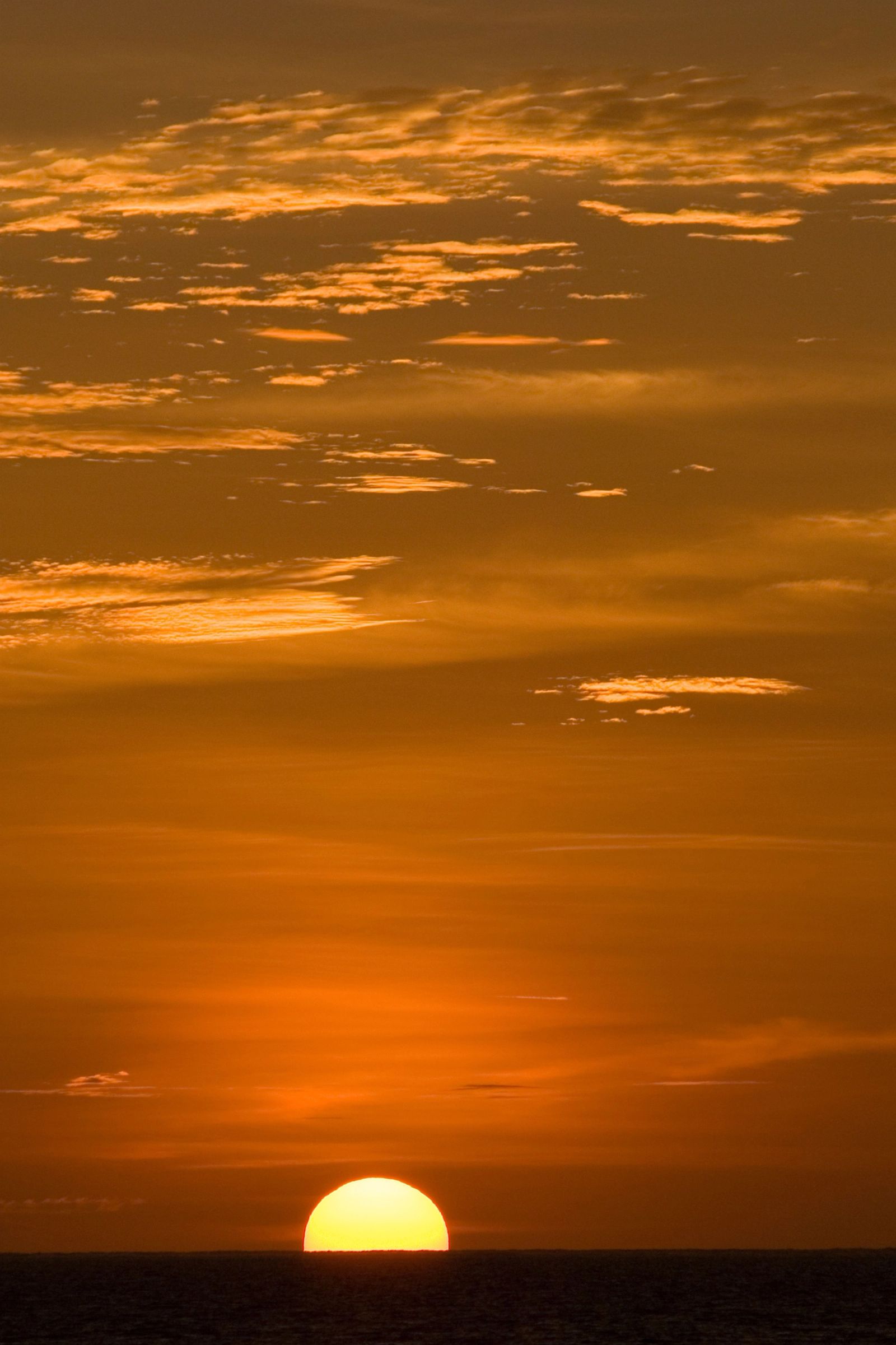 Sunset over the open ocean beyond the reef at Mapia Atoll.