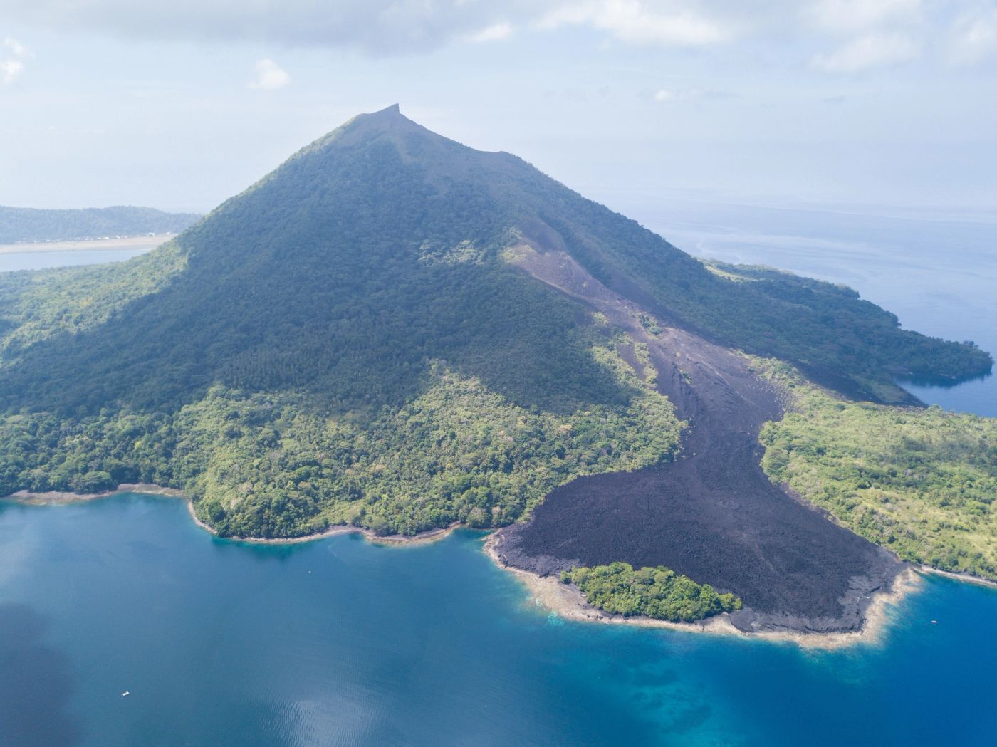 The lava-scarred slopes of Banda Api rising from the sea