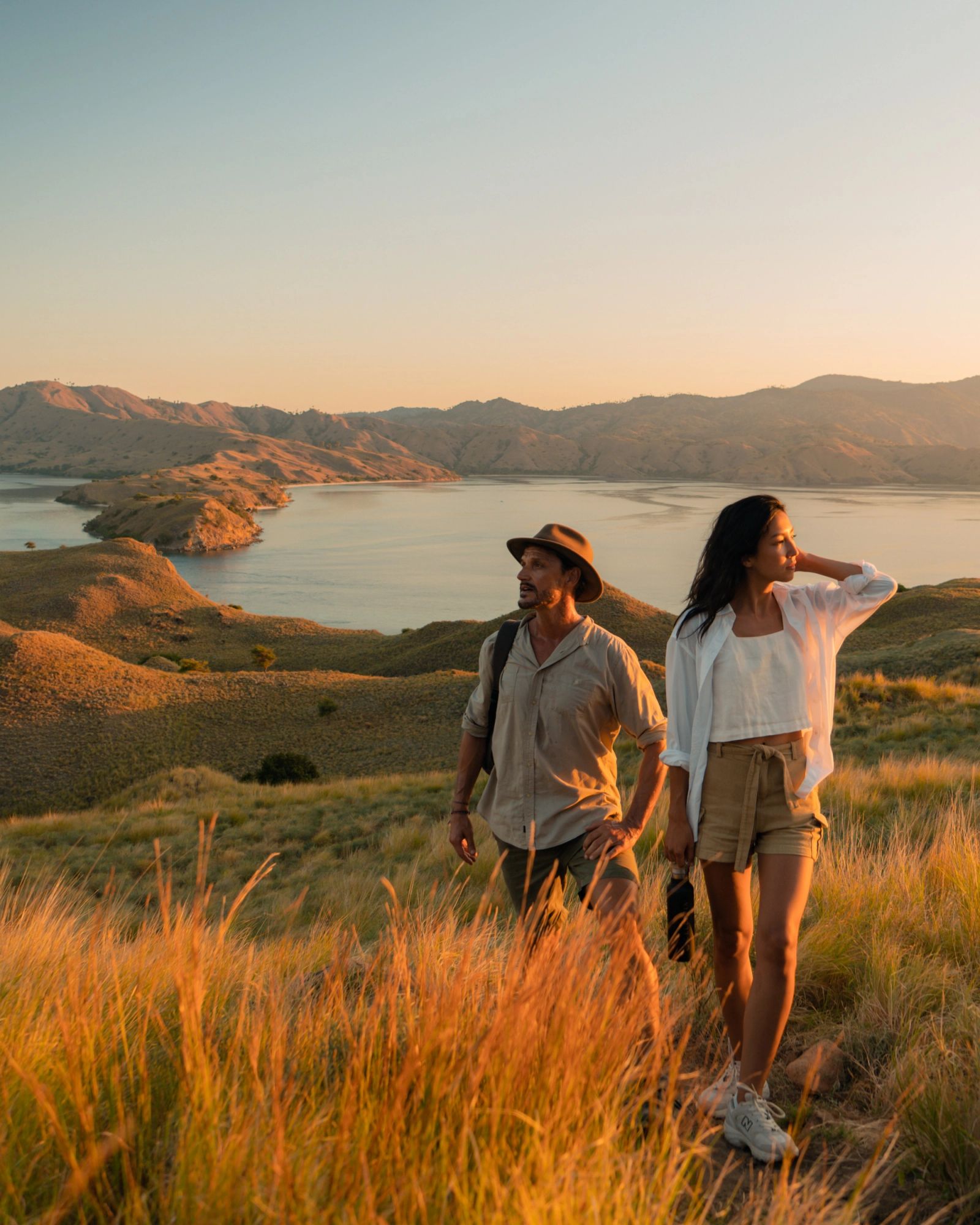 Guests walking a golden ridgeline at sunset
