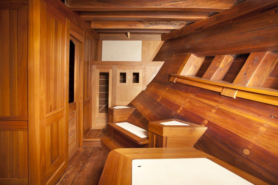 A stateroom taking shape in raw timber during the build