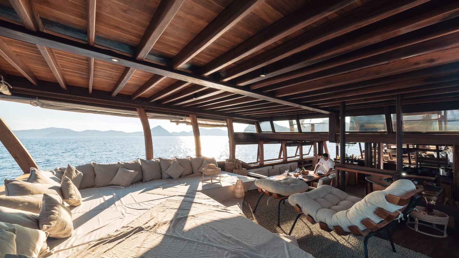 The cushioned aft deck lounge on Nataraja open to the sea.