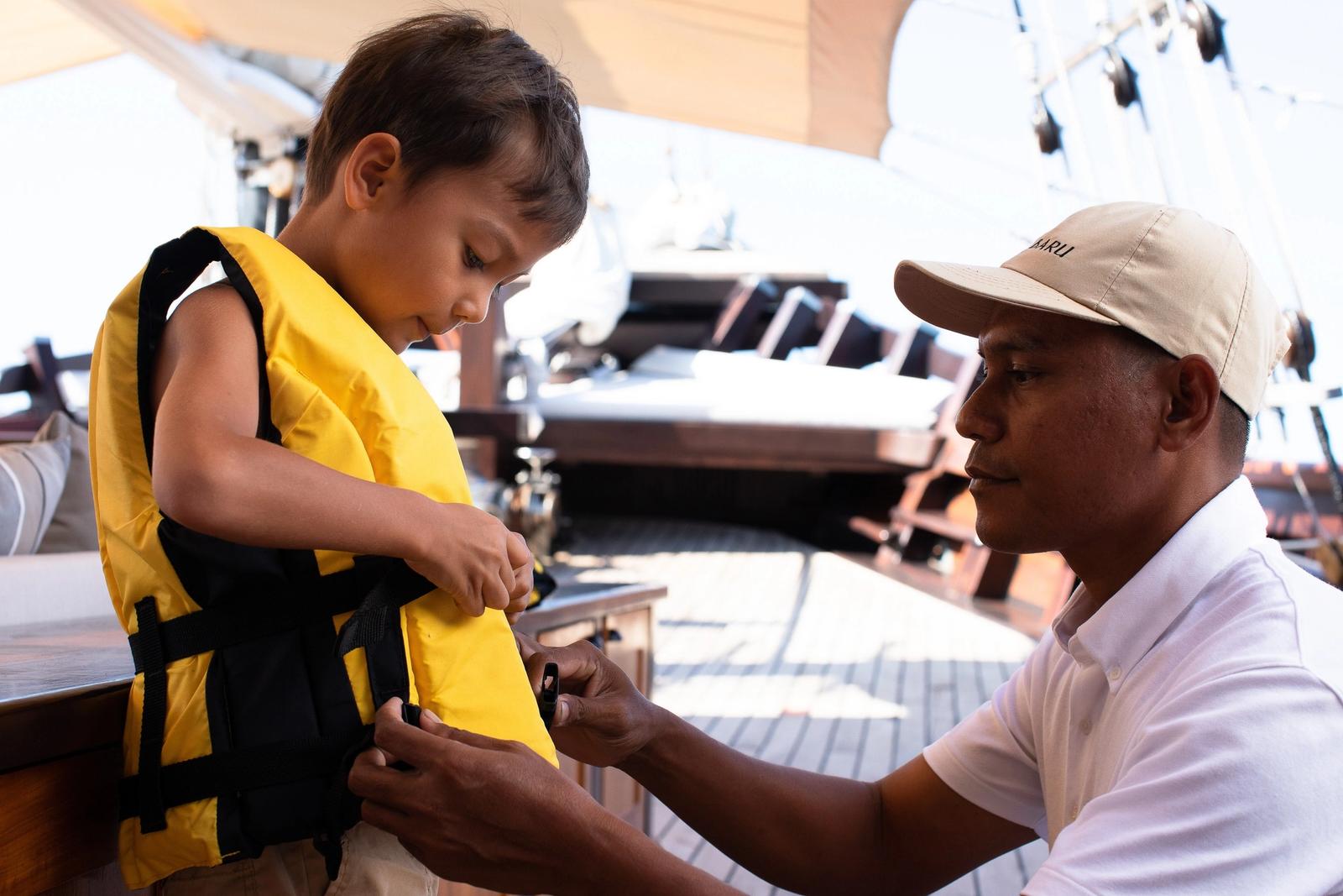A crew member fits a life vest before the first snorkel.