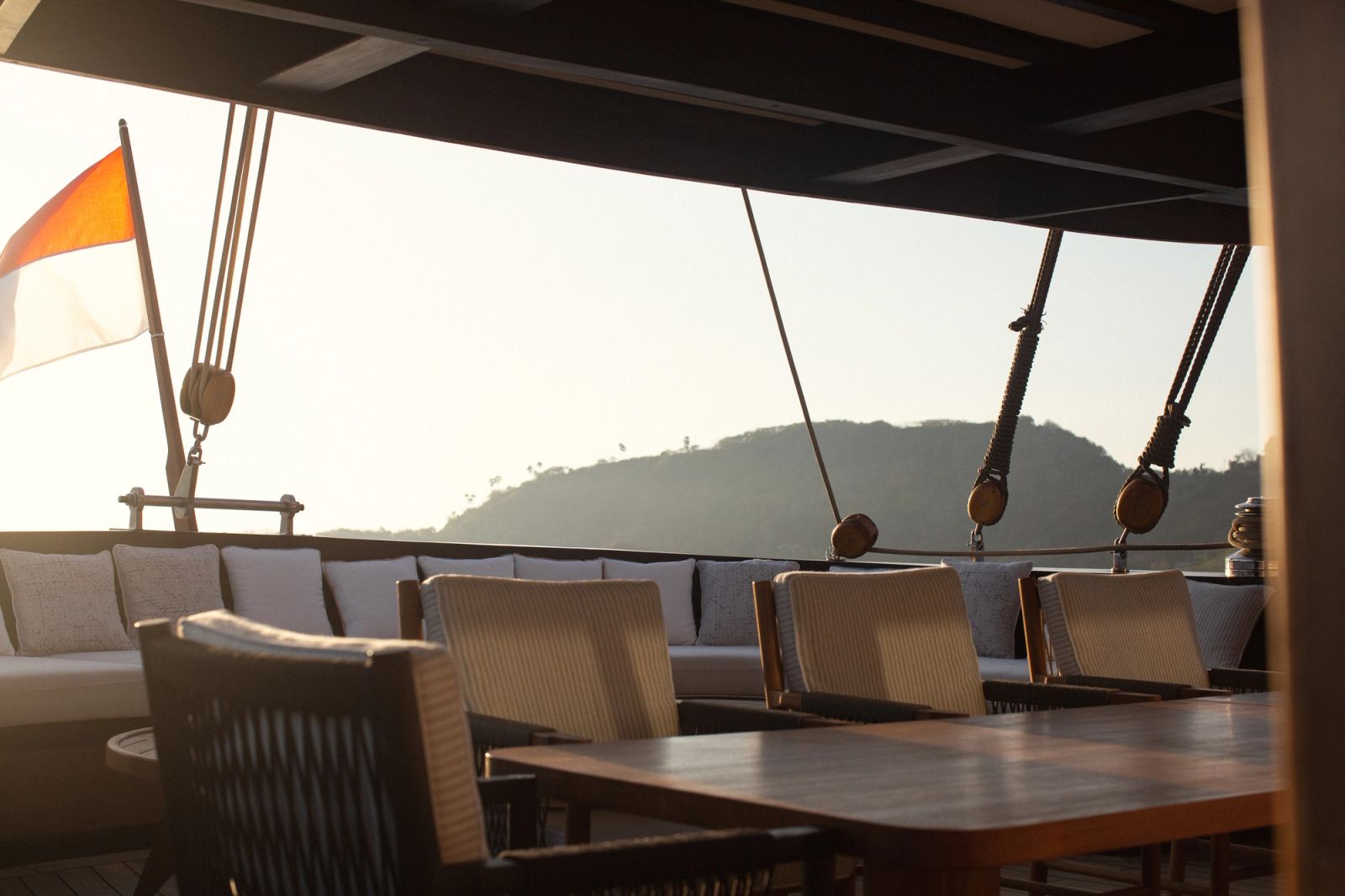 A shaded deck lounge and dining table on Vela