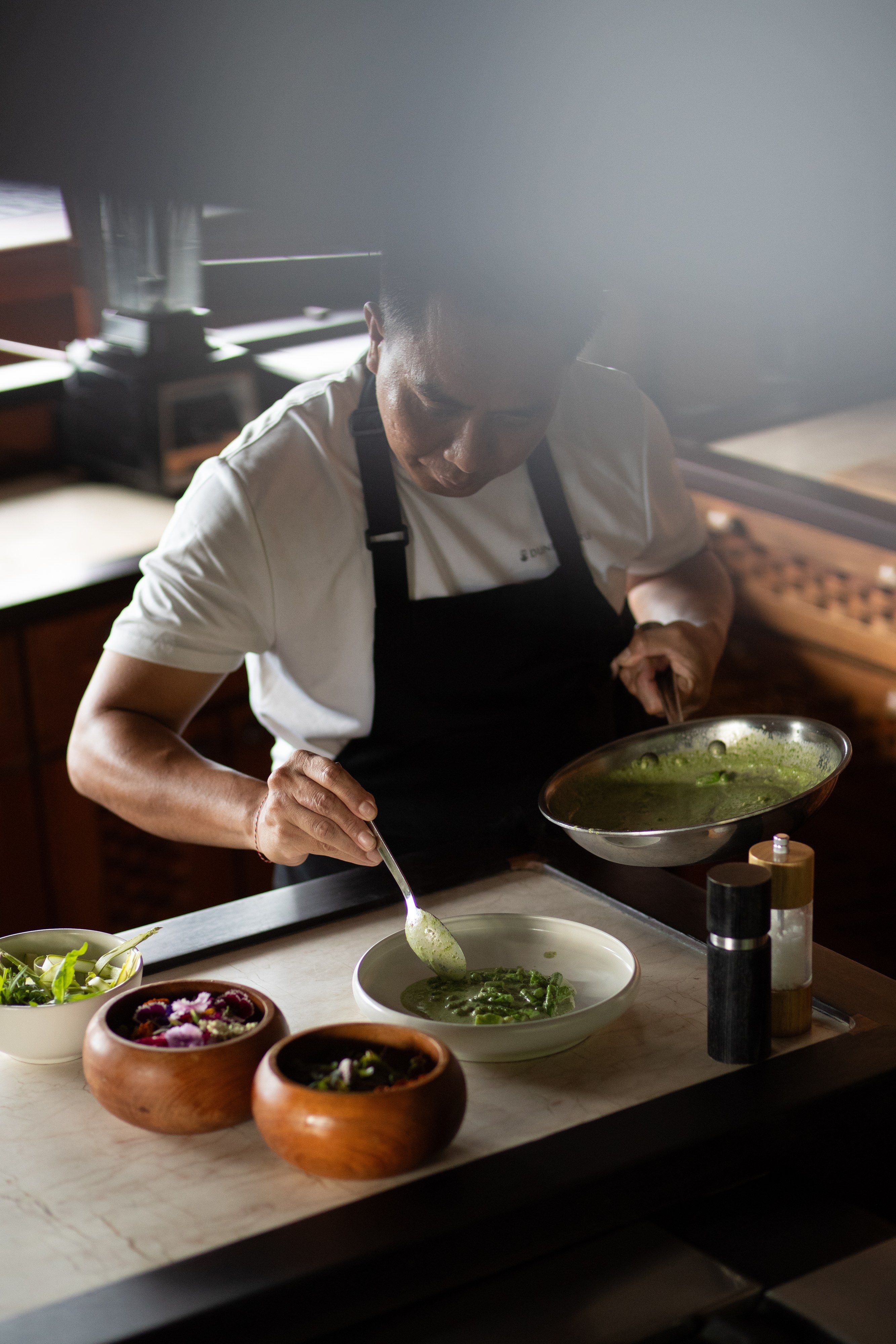 The chef plating lunch in the galley.