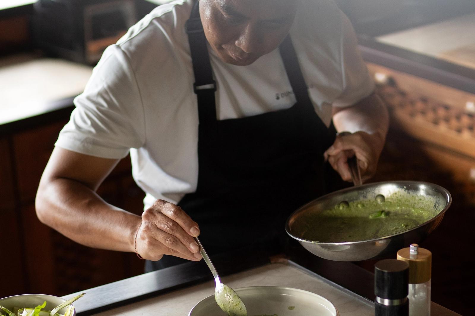 The chef plating lunch in the galley.