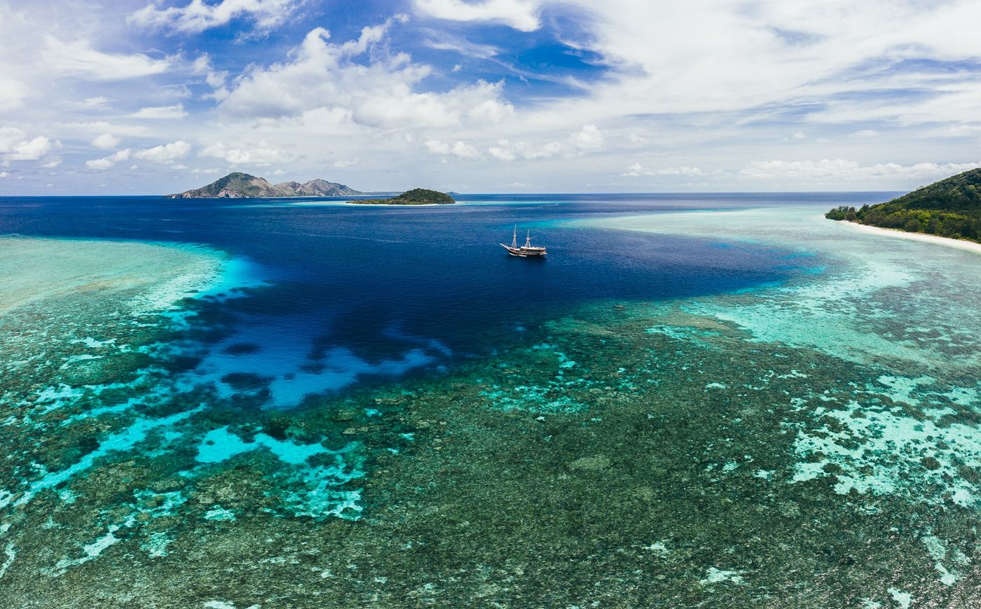 The Seven Seas anchored on a Komodo reef edge from the air