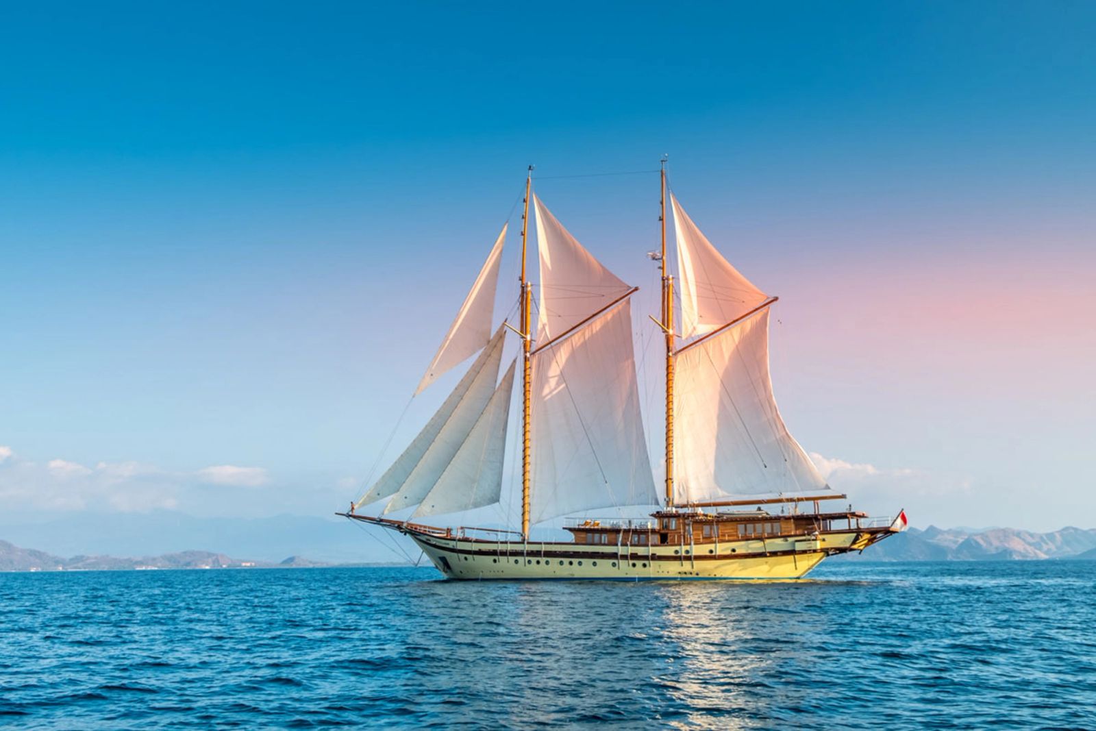 Lamima under full sail on calm blue water
