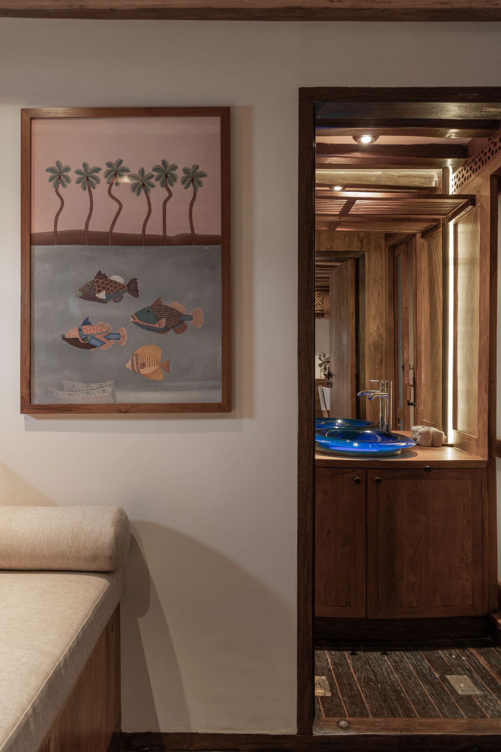 The bathroom entrance in a guest cabin on El Aleph with framed artwork on the wall.