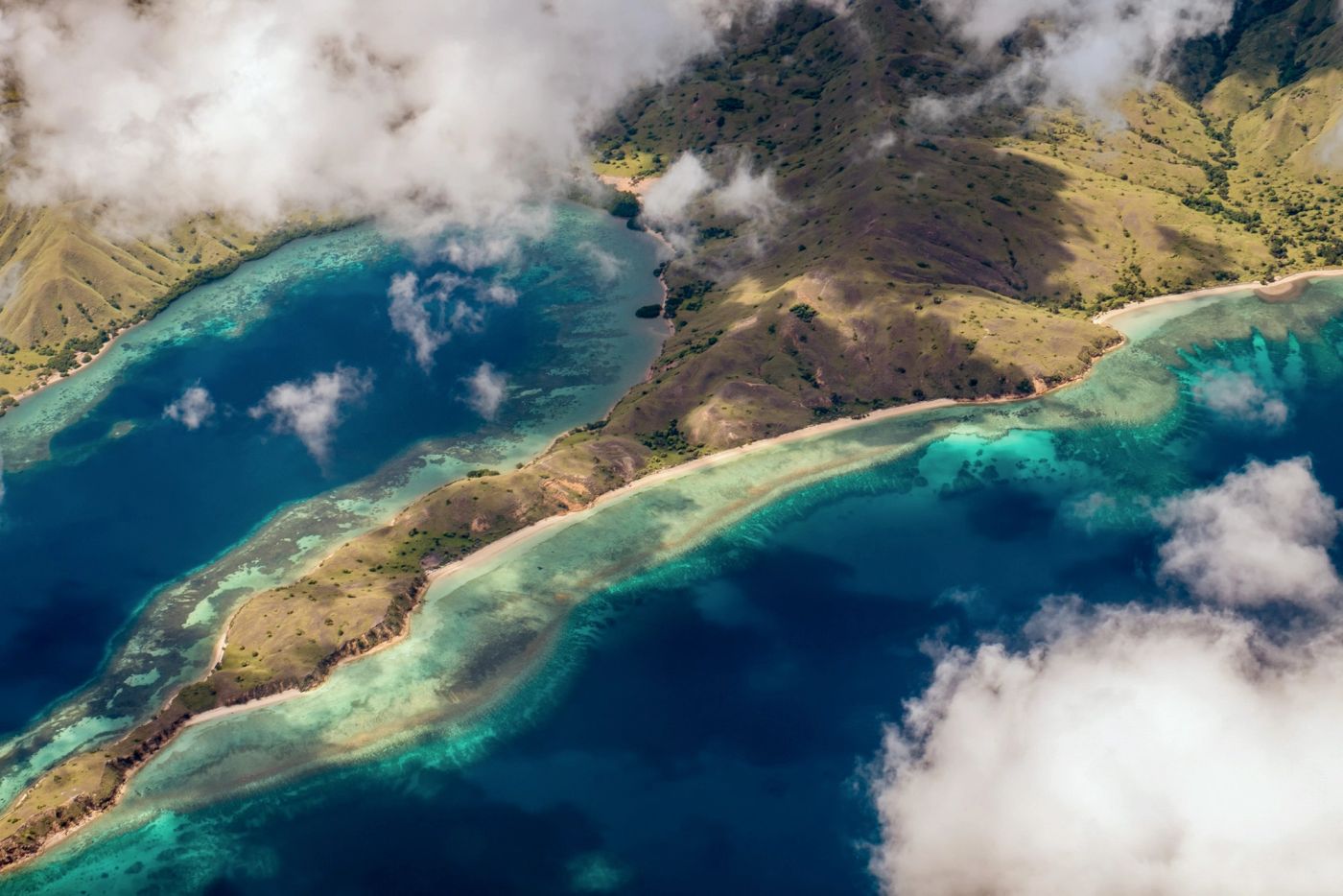 The reef-lined coast of Komodo National Park from the air