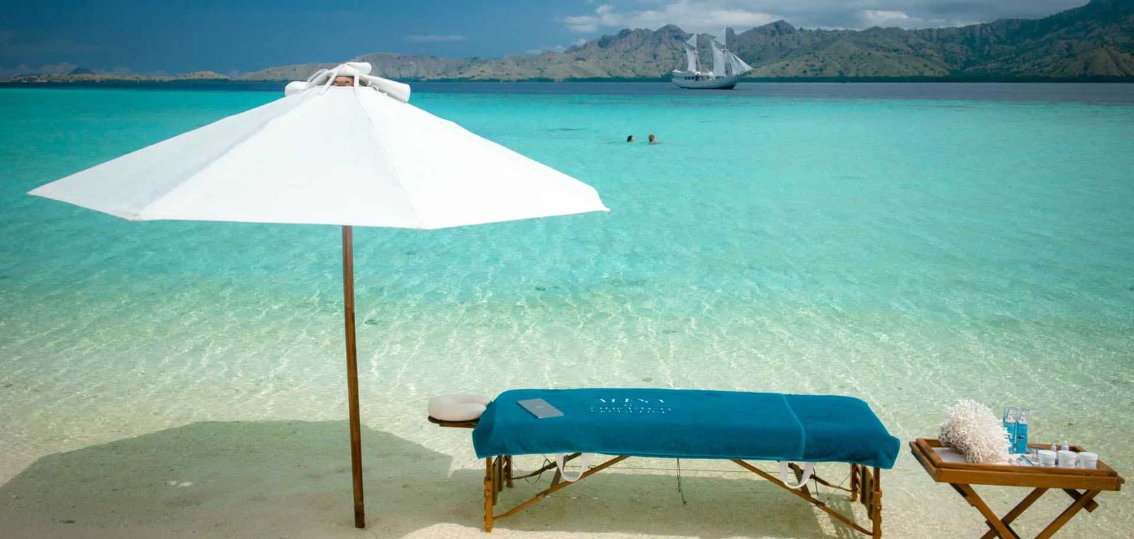 Alexa's massage table set up for a relaxing experience at a secluded beach.