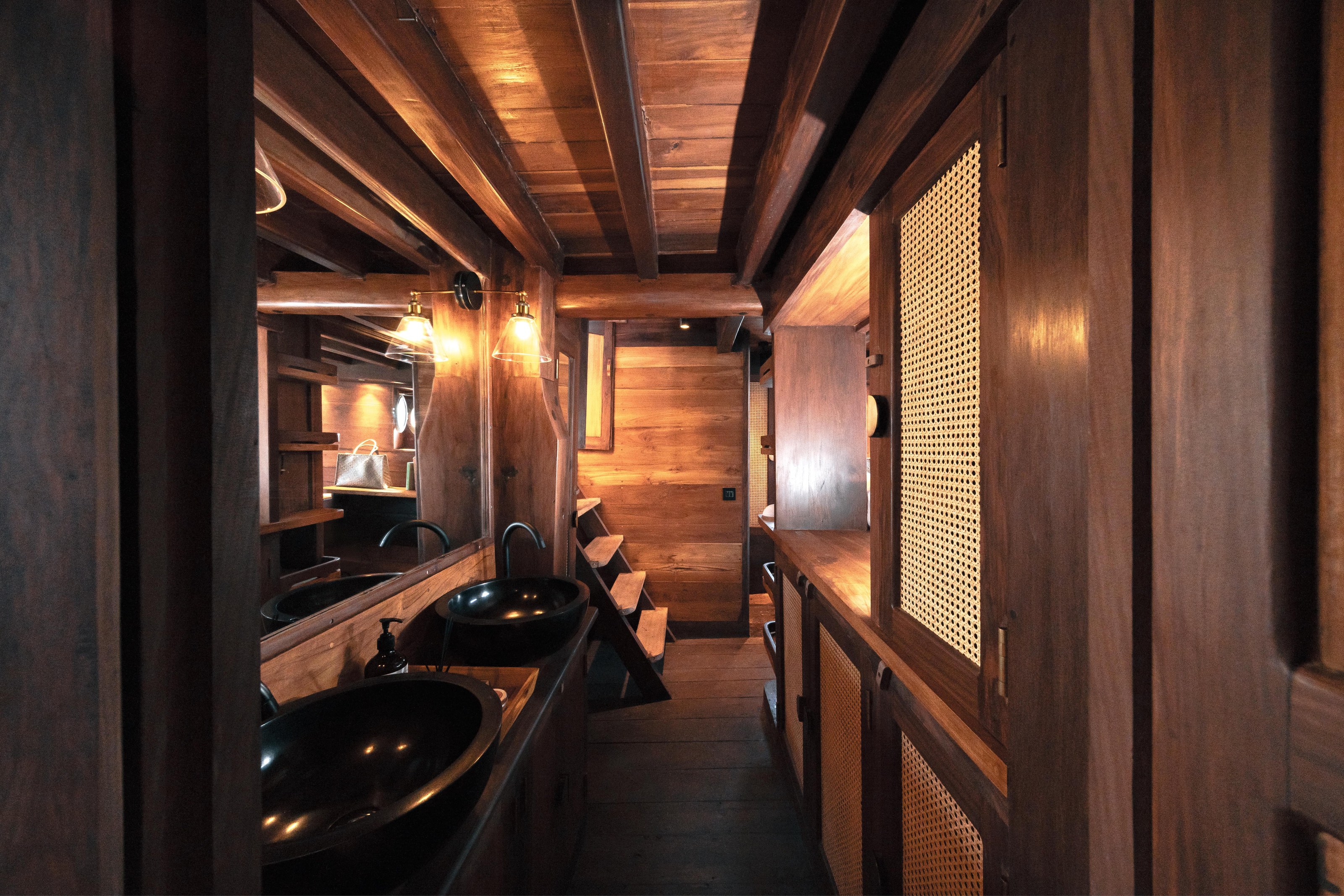 The master cabin bathroom on Nataraja lined in dark timber.