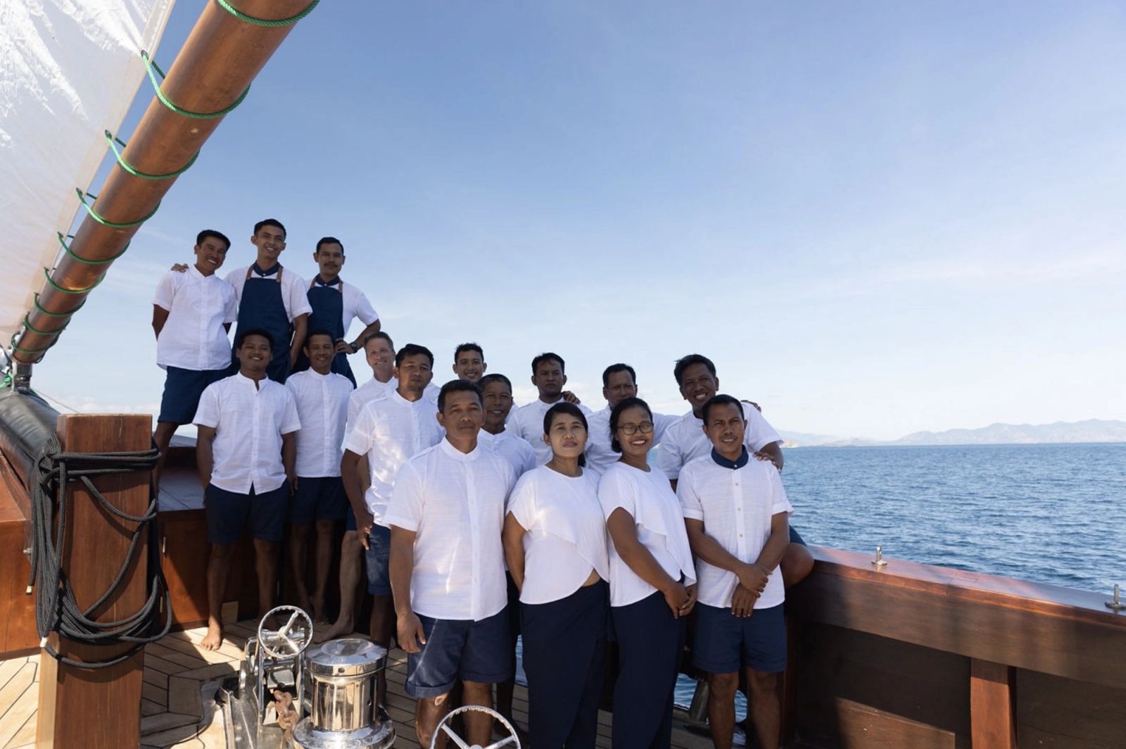Vela's crew gathered on the foredeck in whites