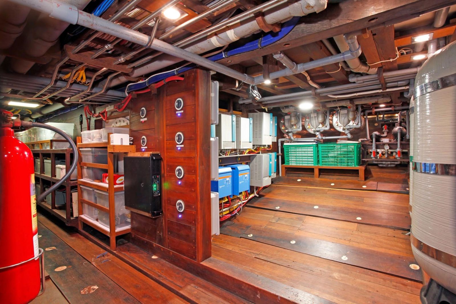 A below-deck technical space with fire equipment and panels