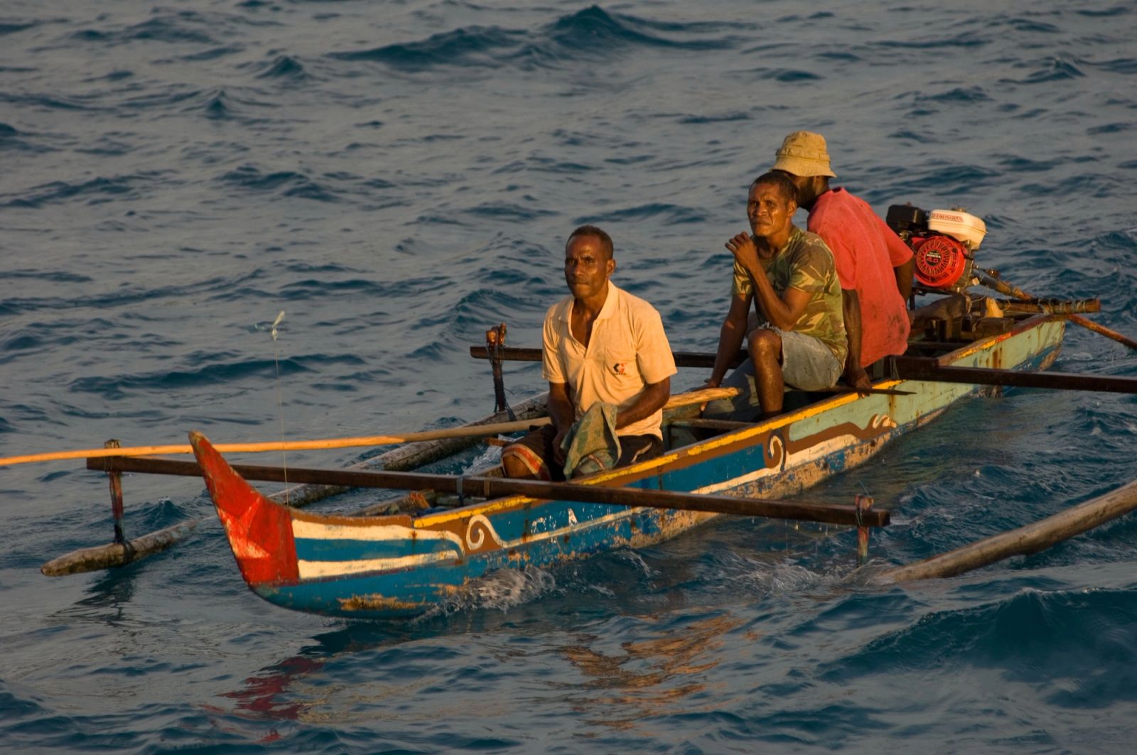 Fishermen in an outrigger canoe, the way people travel between the islets.