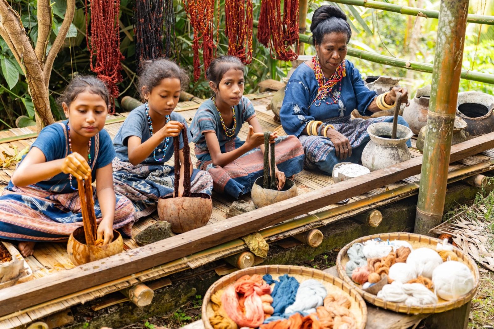 Weavers at work on hand-dyed textiles