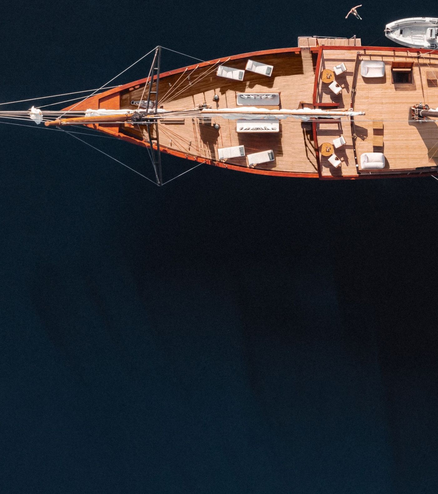 A phinisi seen from directly above on dark water