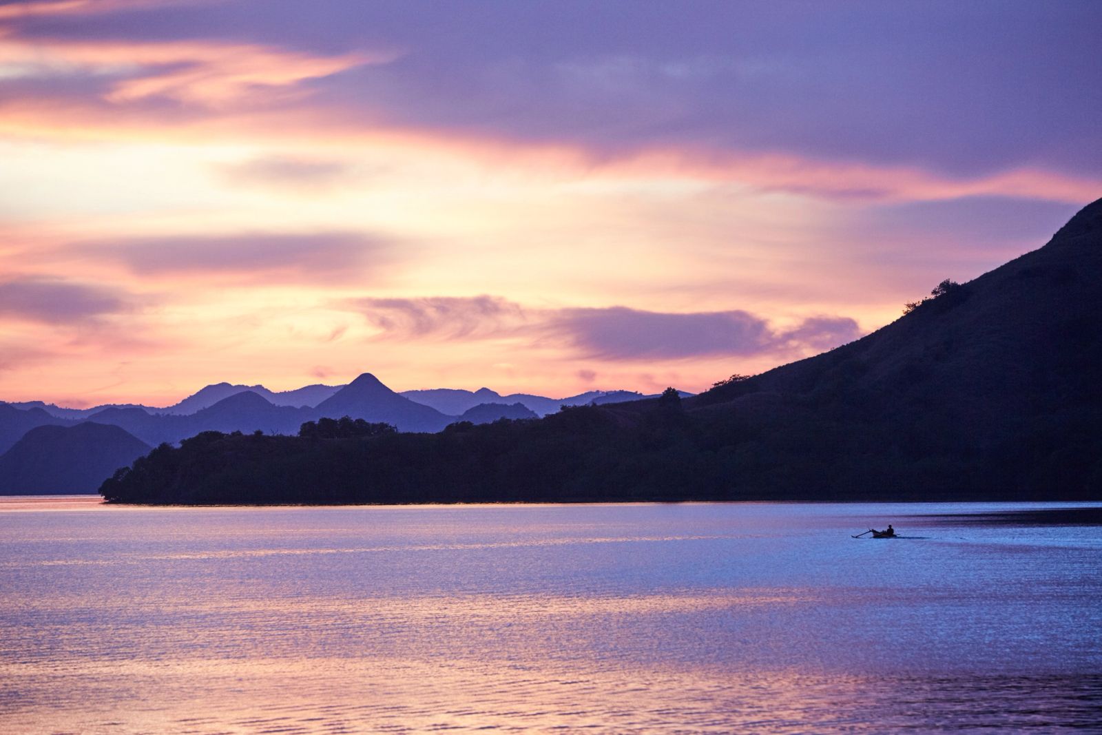 Pink and violet dusk over hills and still water