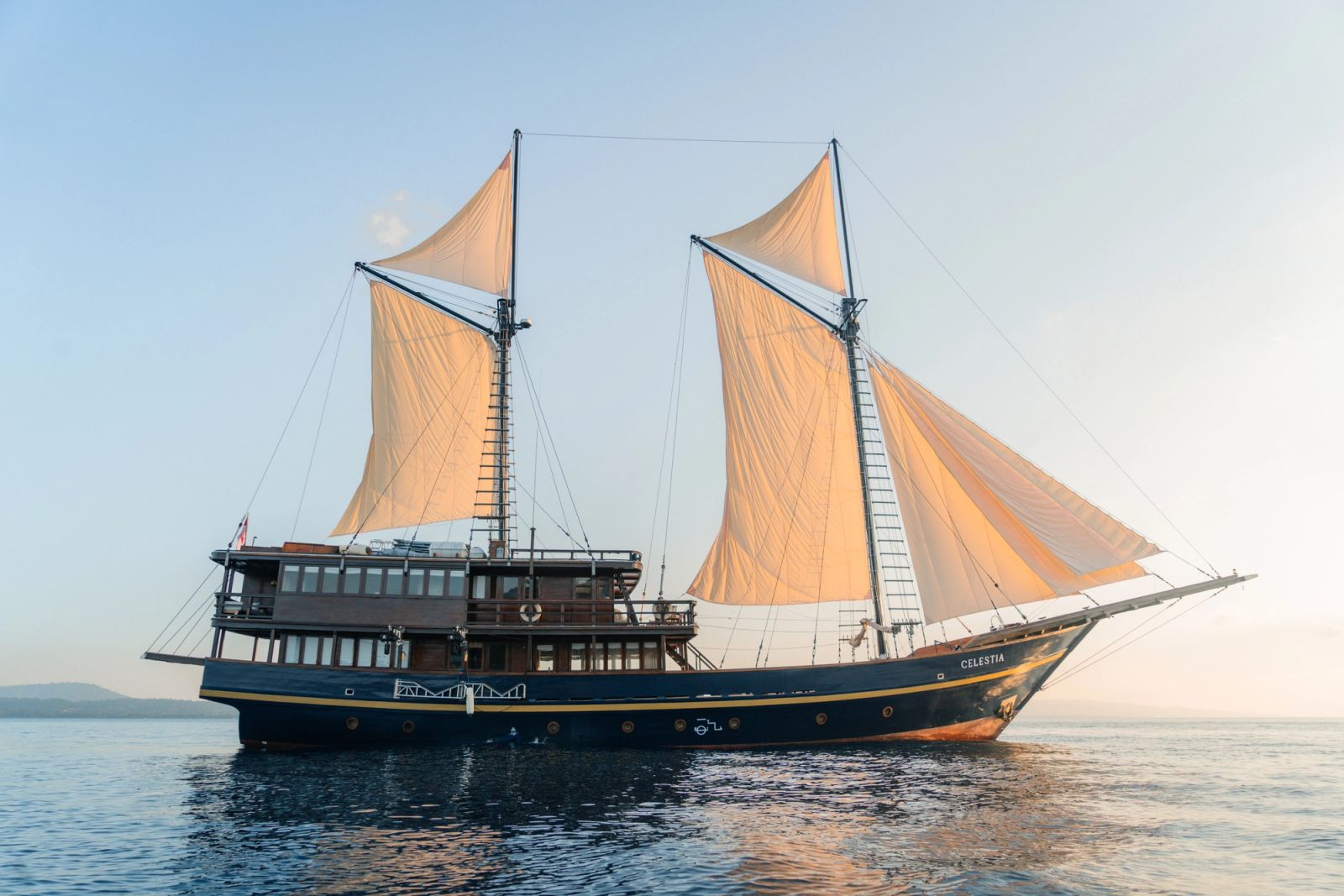 Celestia sailing with both sails set on a calm sea.