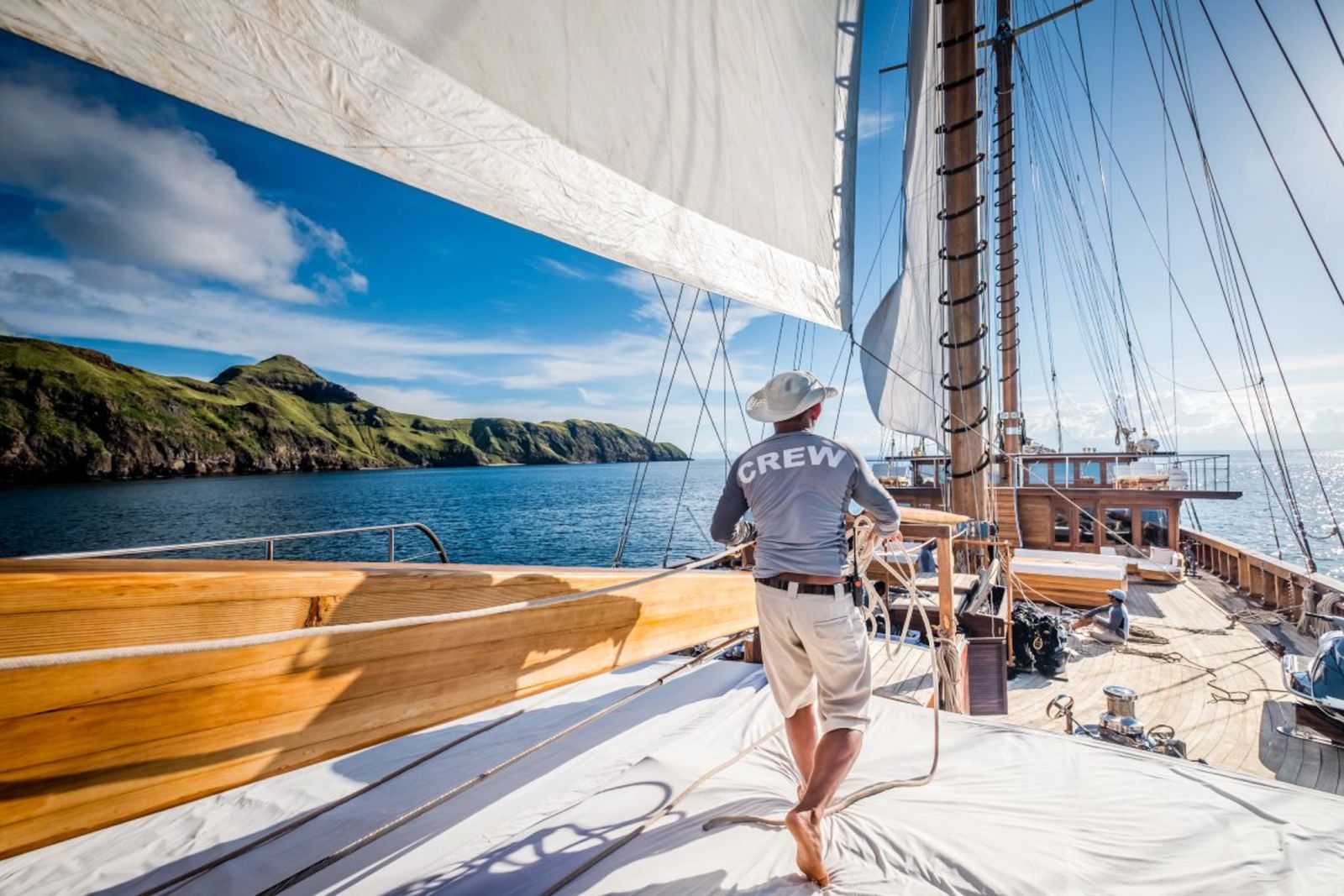 A crew member working the foredeck of Lamima under full sail