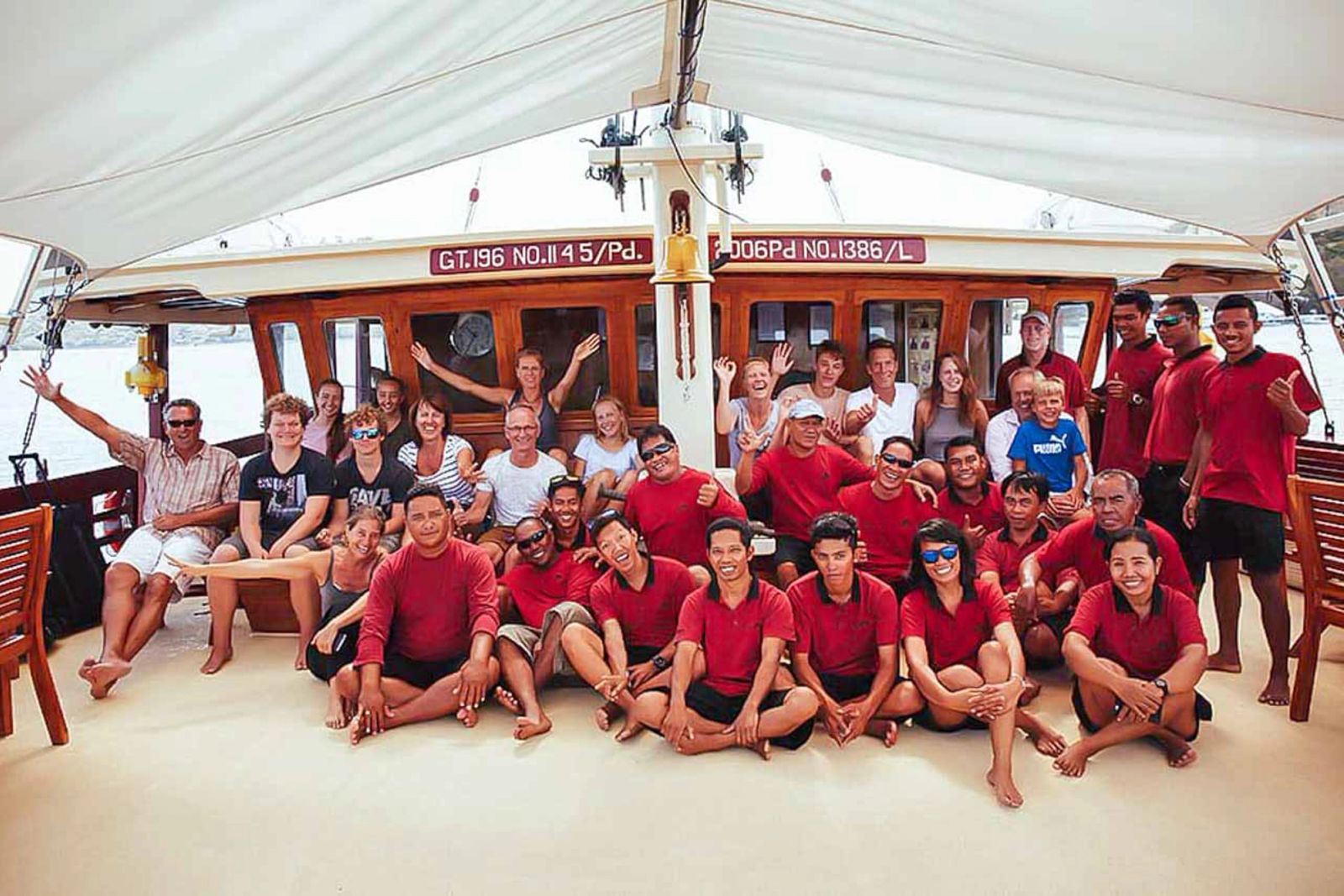 Guests and crew gathered on the aft deck of The Seven Seas