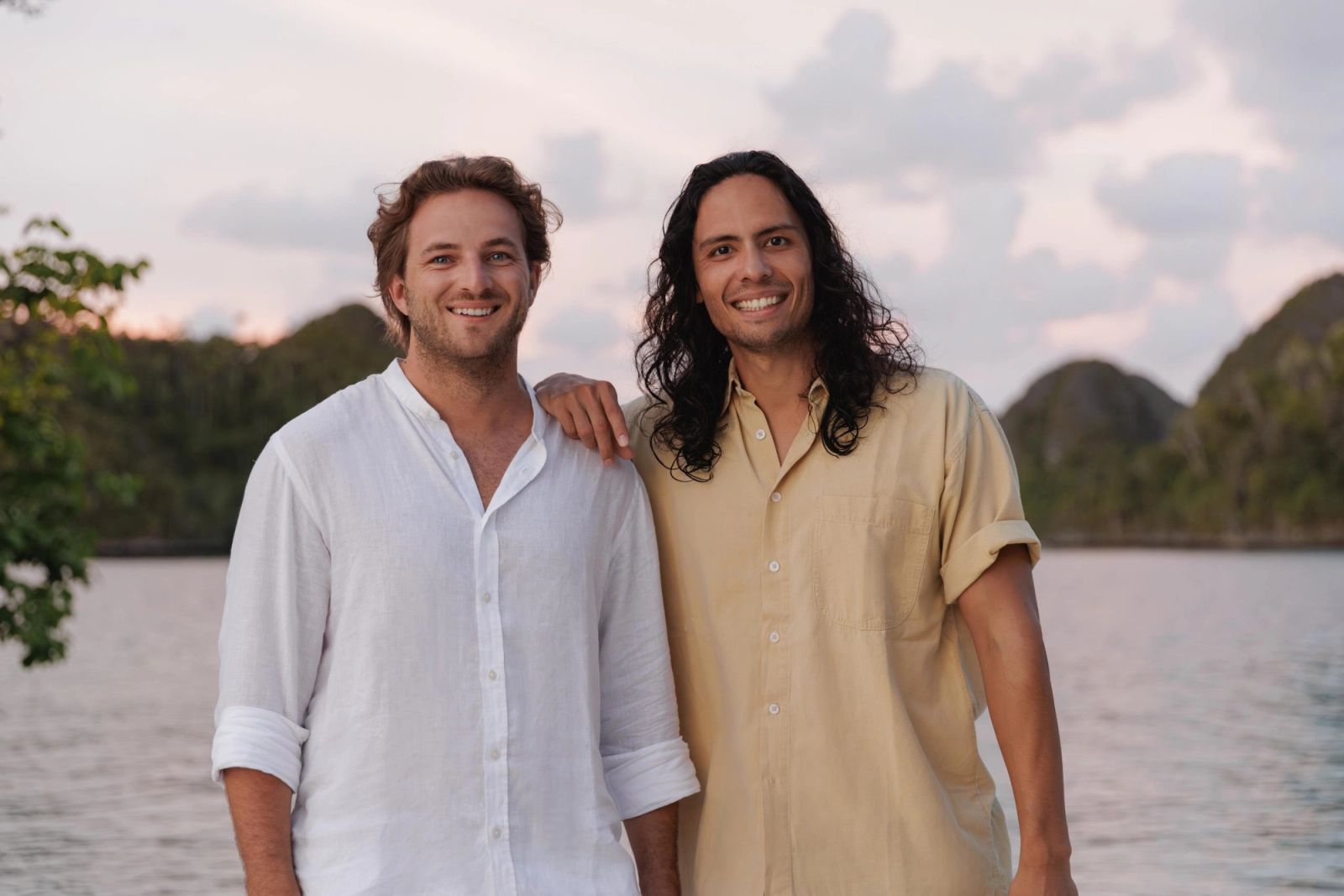 Adrien Portier and Dimitri Tran standing before a Raja Ampat lagoon