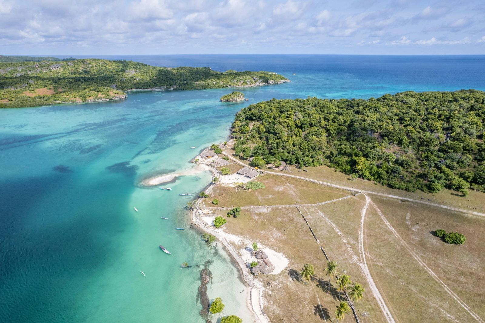 Oeseli village and its turquoise shallows on Rote, where a yacht charter reaches beyond the surf.
