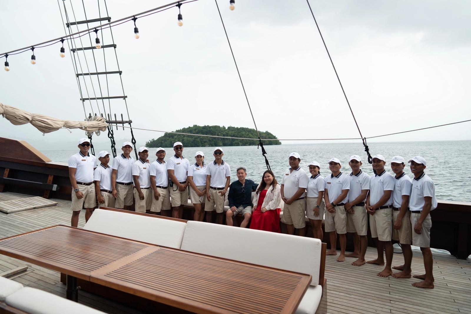 The crew gather on deck, often outnumbering the guests.