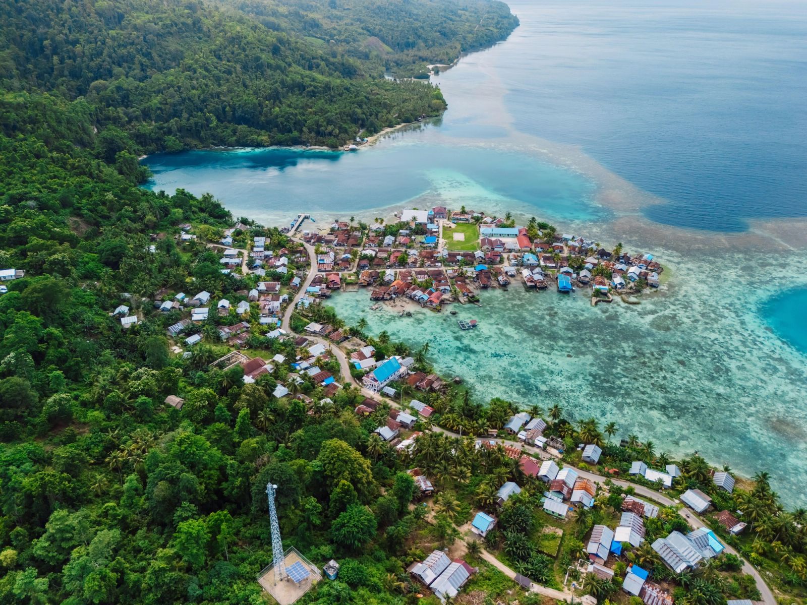 A reef-fringed village on the coast of the Banggai archipelago, seen from the air.