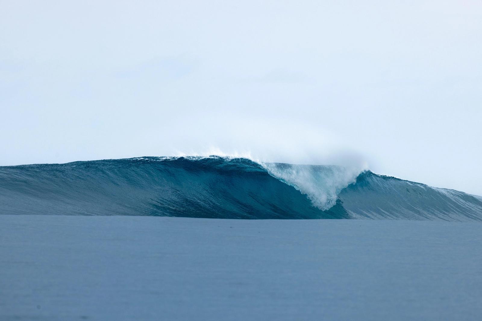 A clean, empty wave peeling over a shallow Mentawai reef