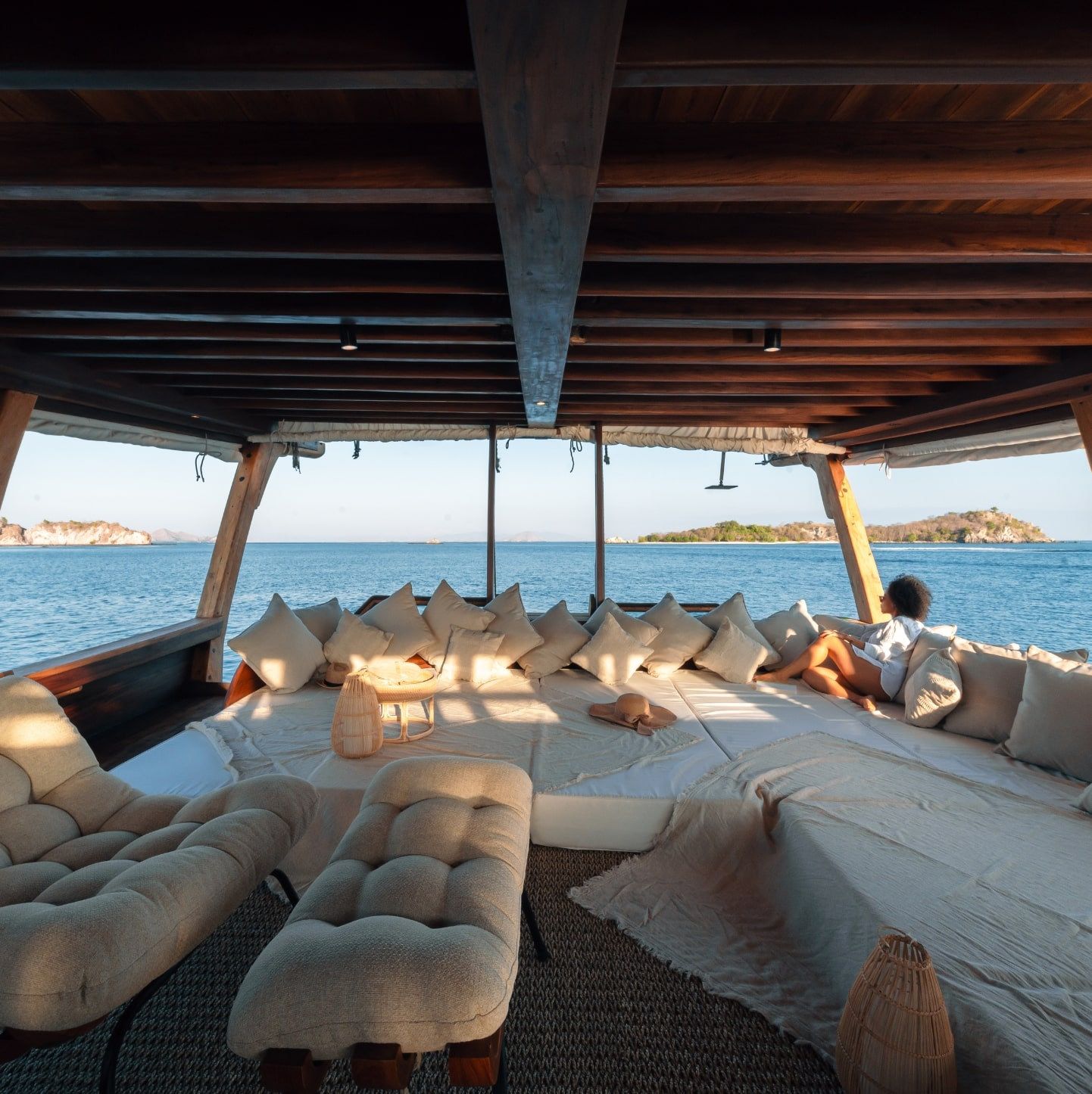 The cushioned aft deck lounge on Nataraja open to the sea.