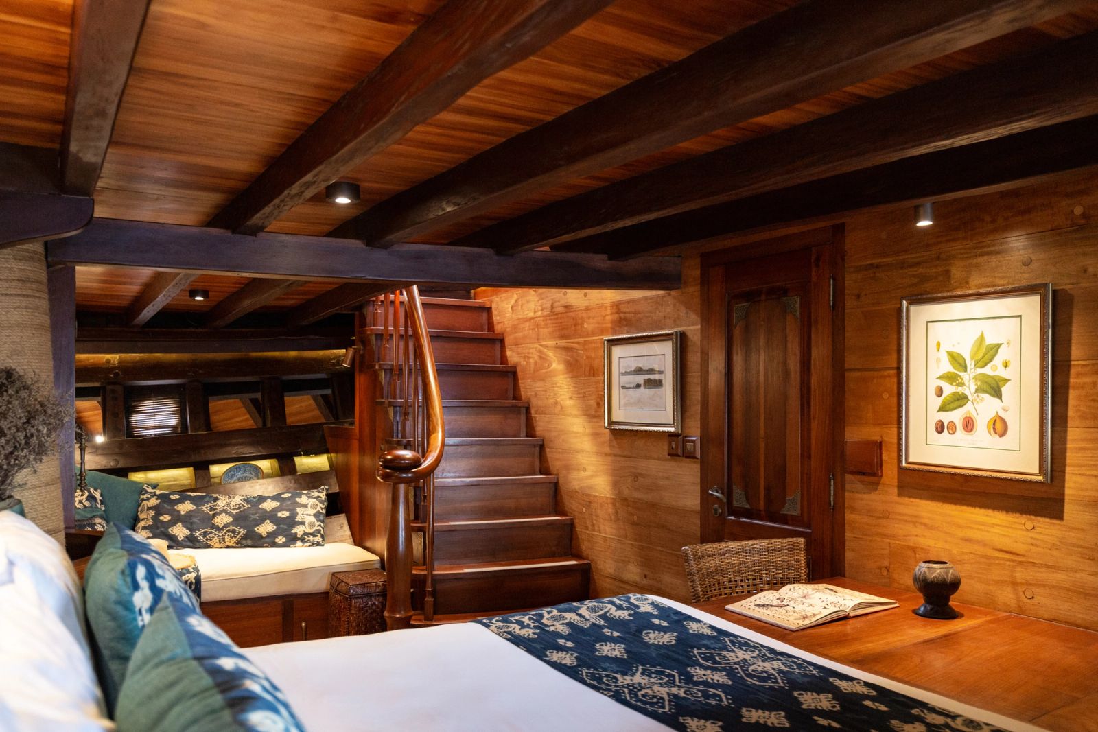 The Banda cabin aboard Si Datu Bua, with timber panelling and a carved staircase