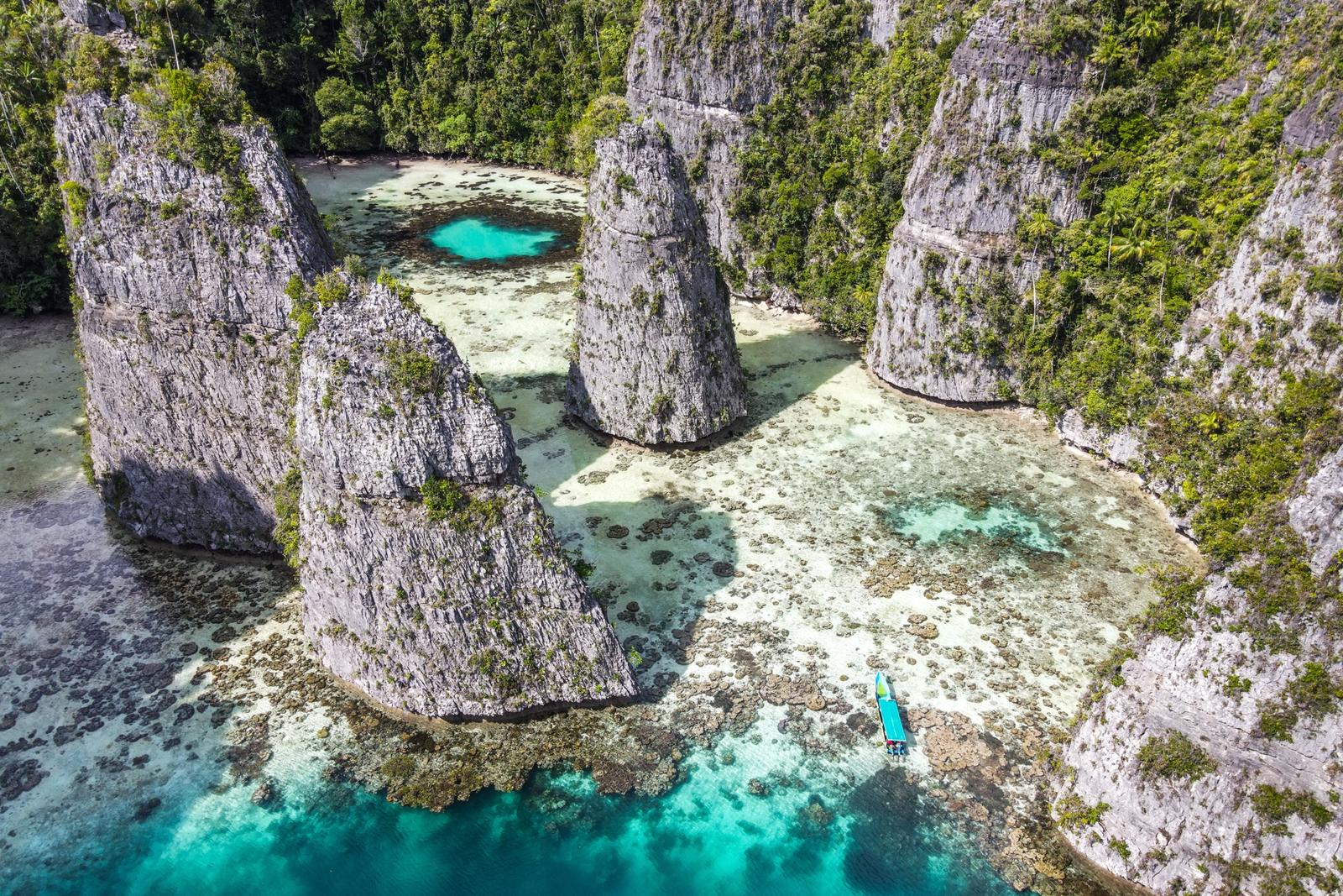 Aerial view of Pulau Balbulol in Misool, Raja Ampat, with turquoise lagoons among limestone islands