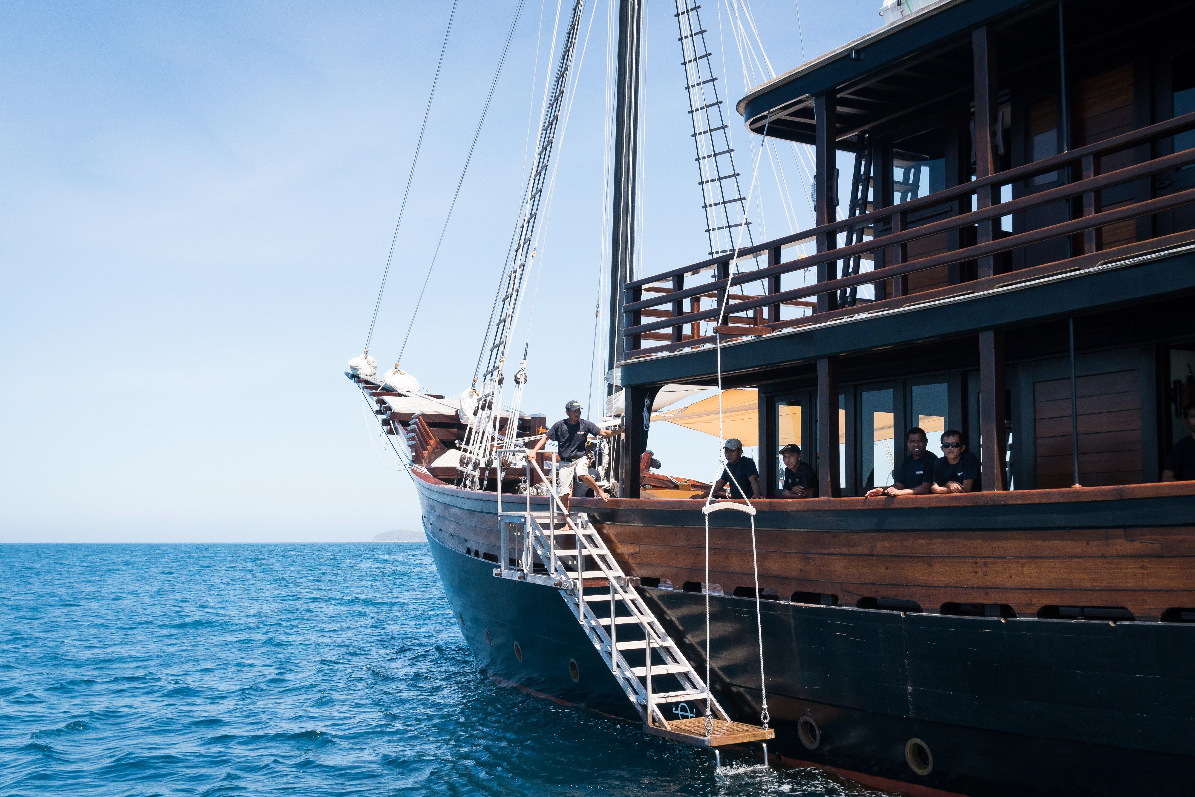 The bow and boarding ladder of a phinisi seen from the water