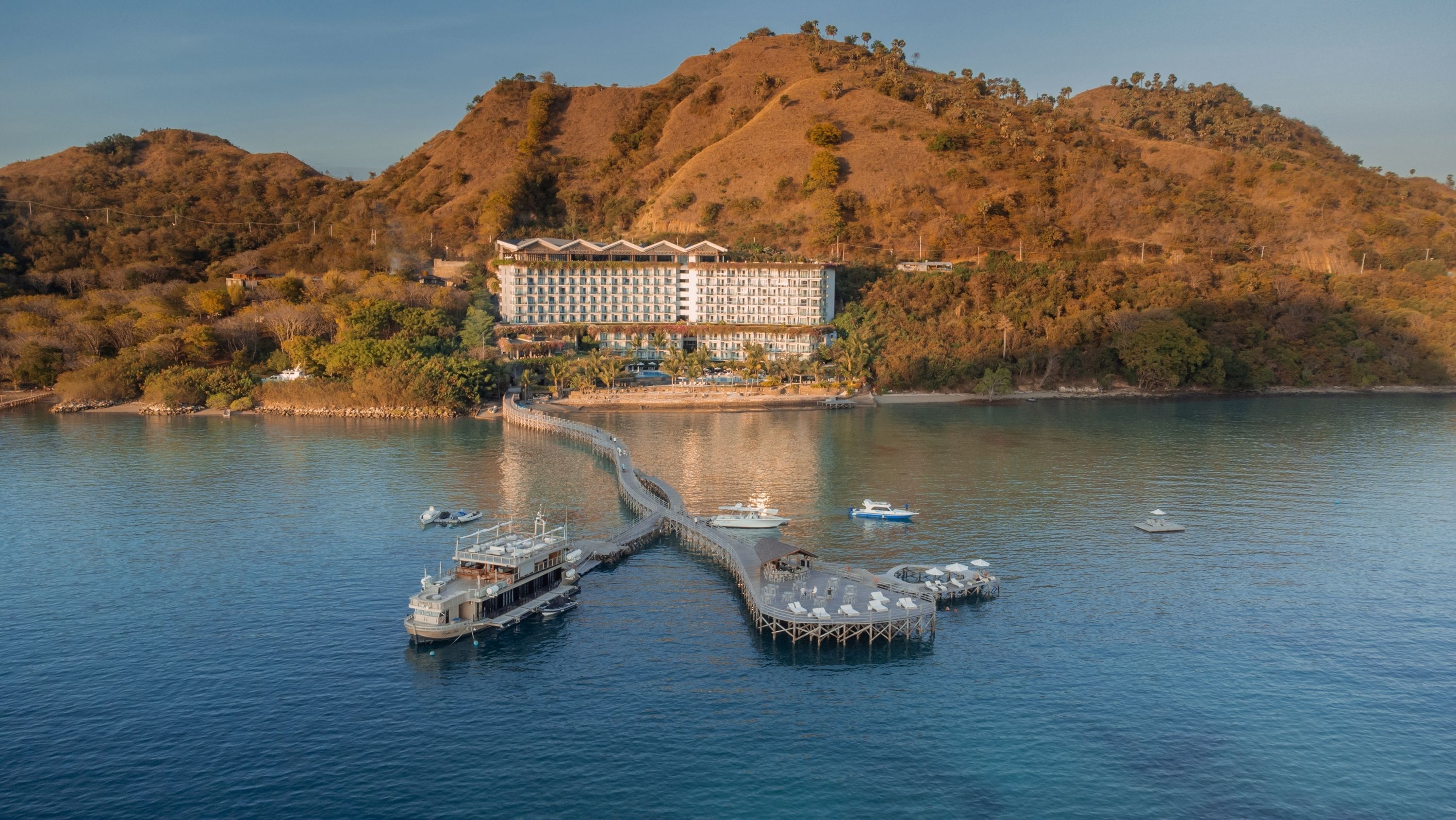 A hillside hotel and long jetty on the water near Labuan Bajo
