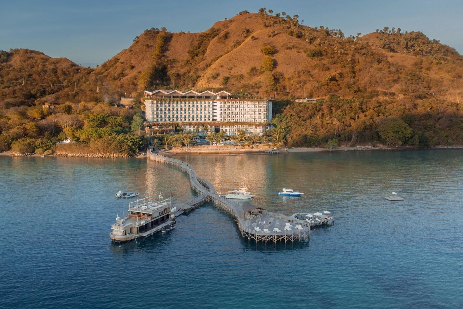 A hillside hotel and long jetty on the water near Labuan Bajo